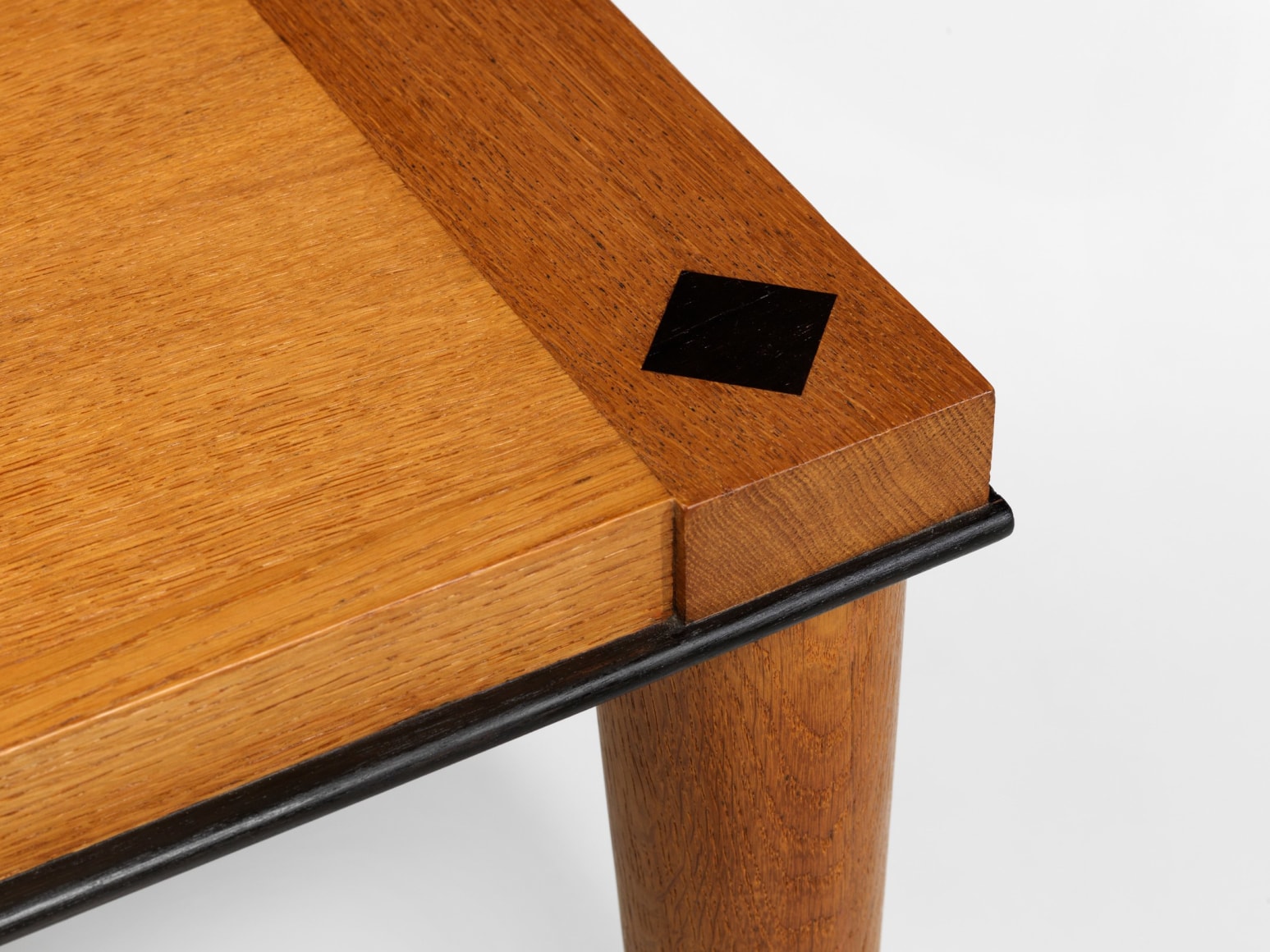 photograph of wood dining table in a blank room