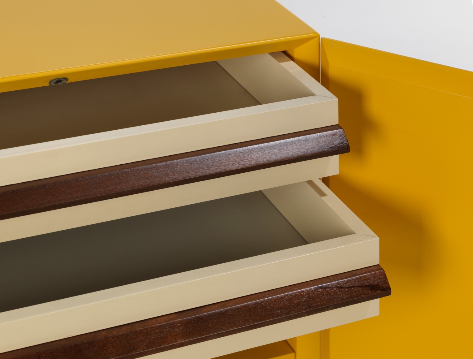 photograph of a yellow cabinet in a blank room