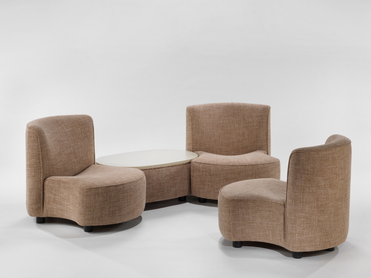 photograph of 3 chairs by Govin, chairs are beige, two are connected by a low table with a white top