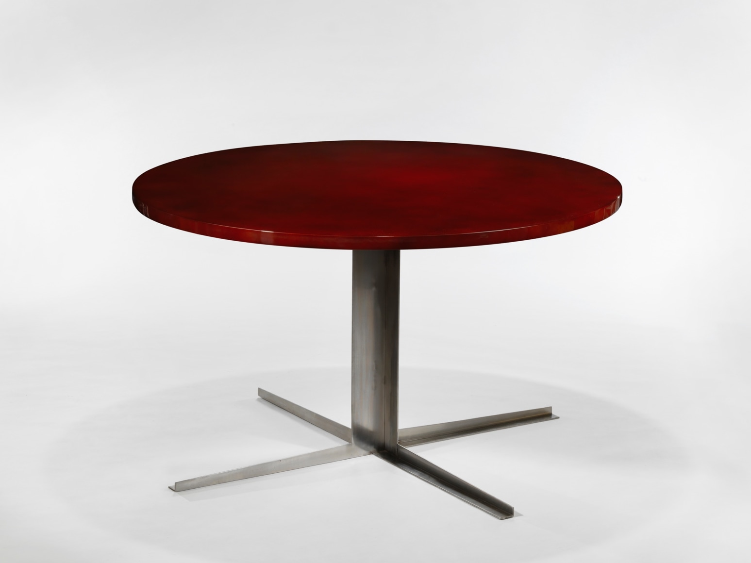 photo of a red dining table in a white room