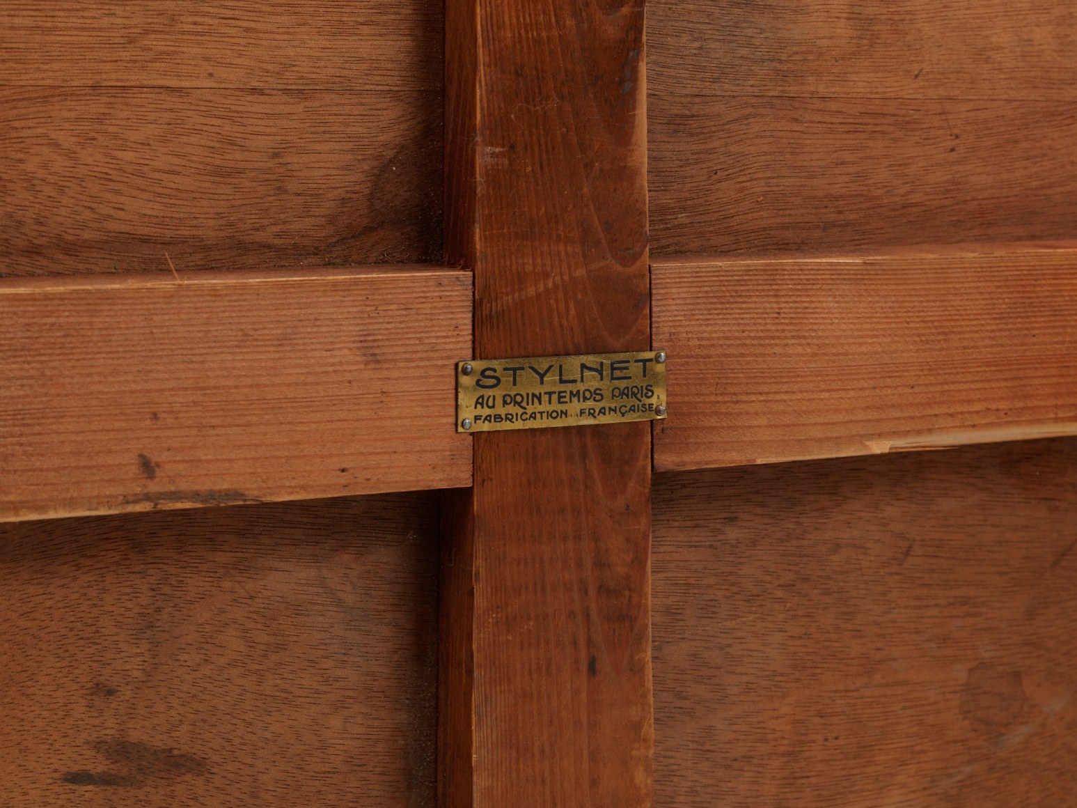 Detail of brass plaque on underside of table