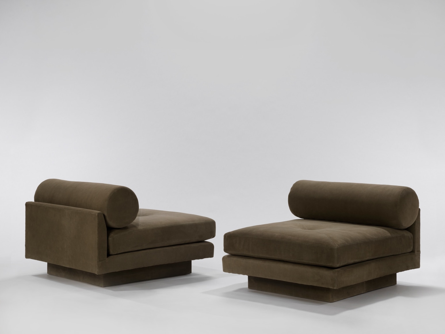 Deep seated upholstered chairs with round bolster pillow