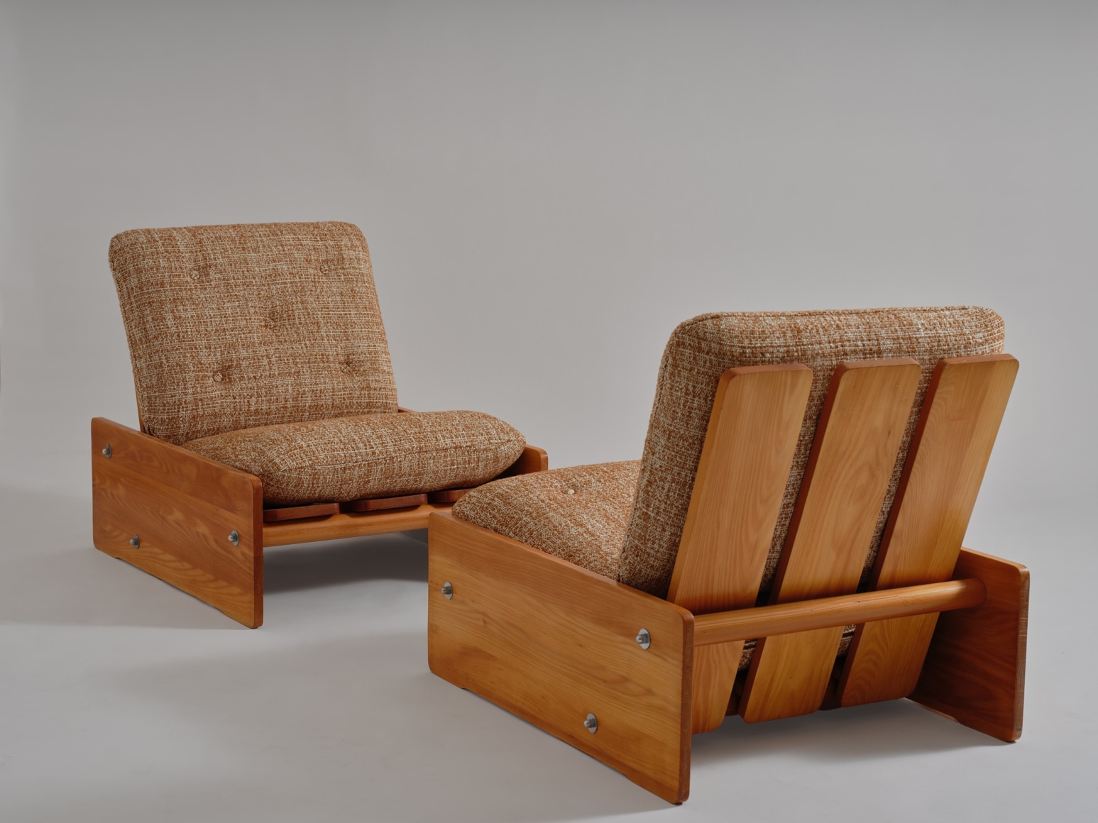 mcm sofa chairs in an empty room