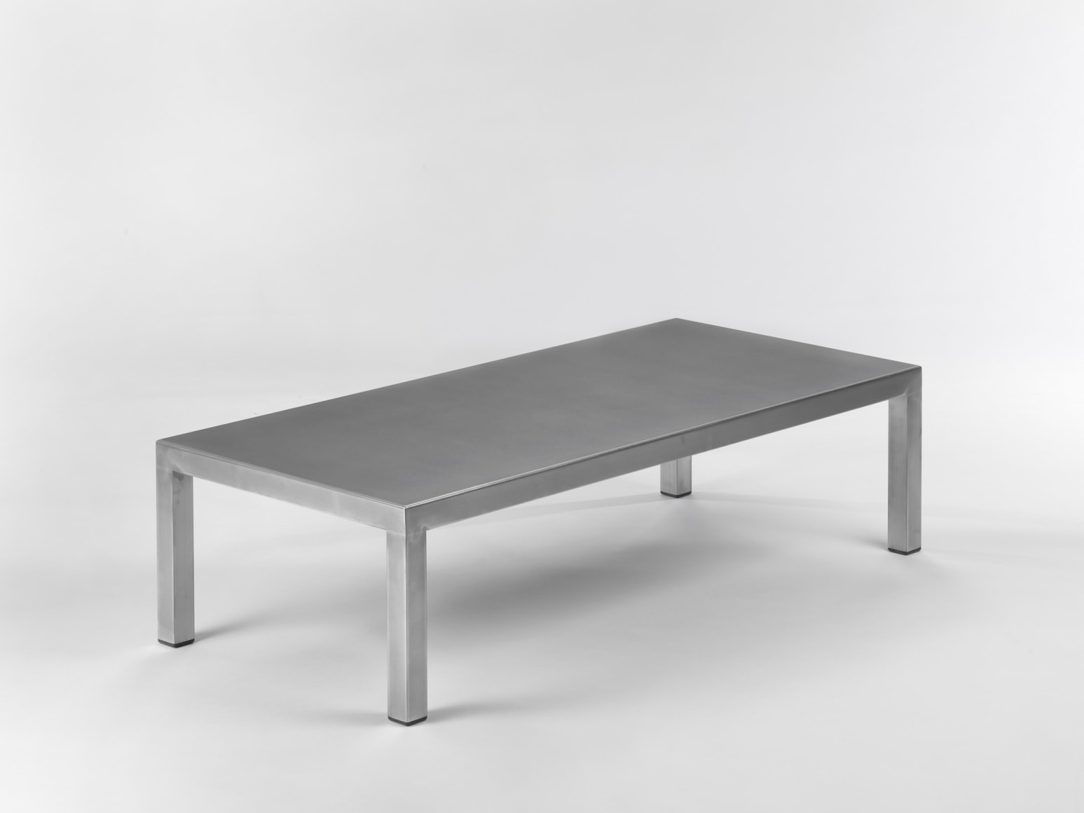 Stainless steel low table in front of white background