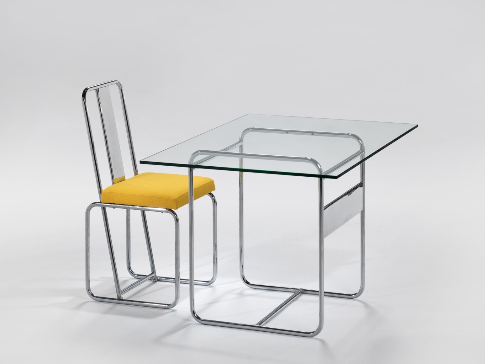 Arnal desk in an empty room with yellow chair