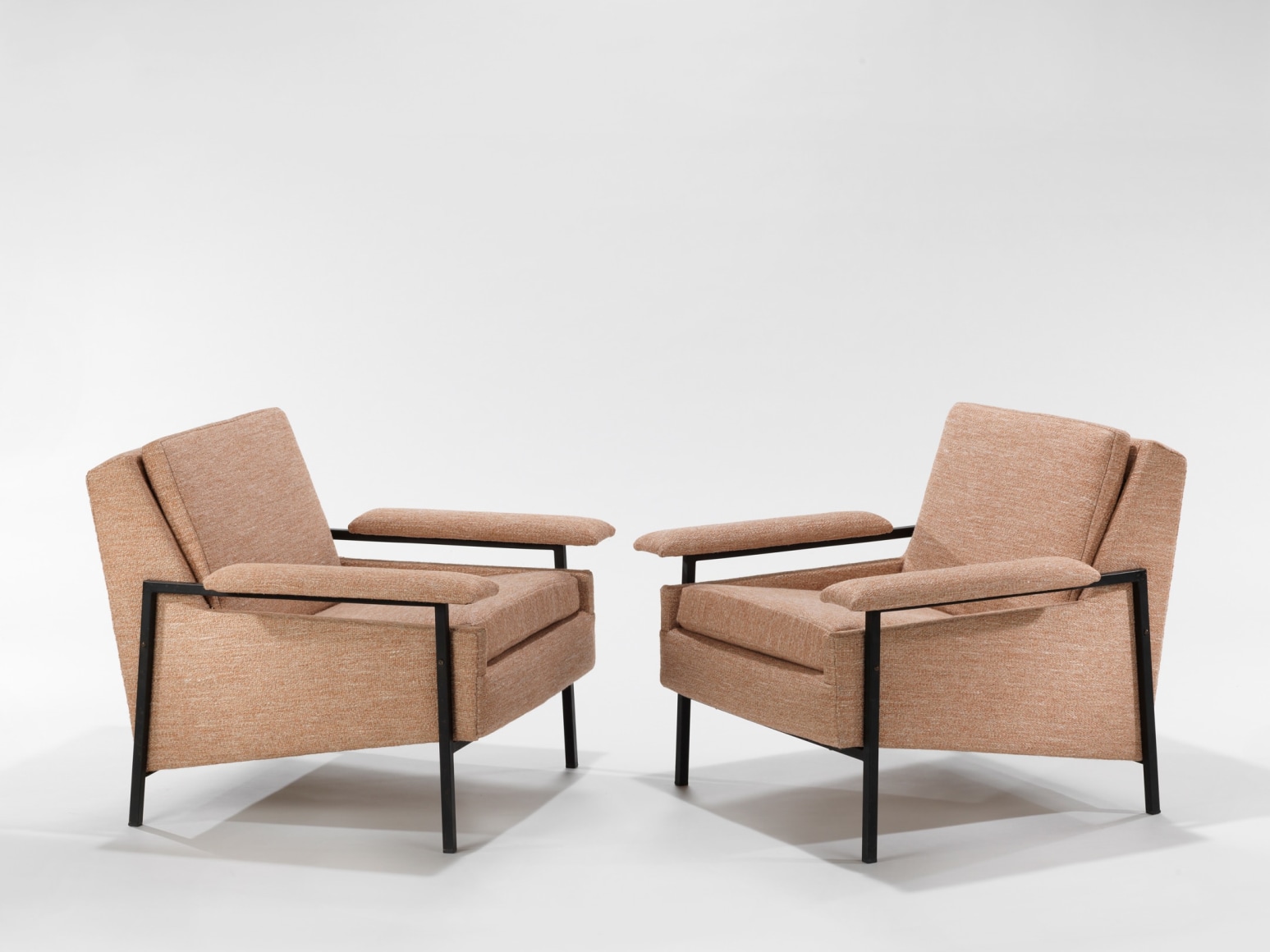 two pink armchairs in an empty room