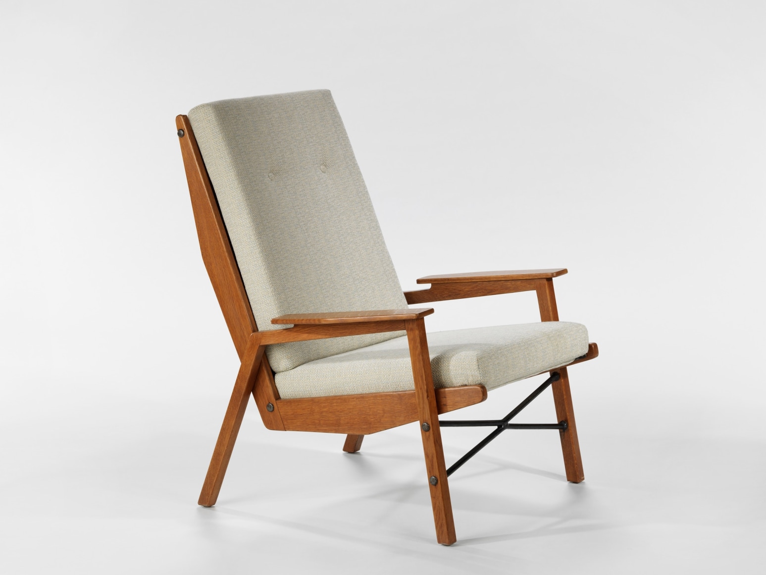 chair with wood legs and arms in a blank room