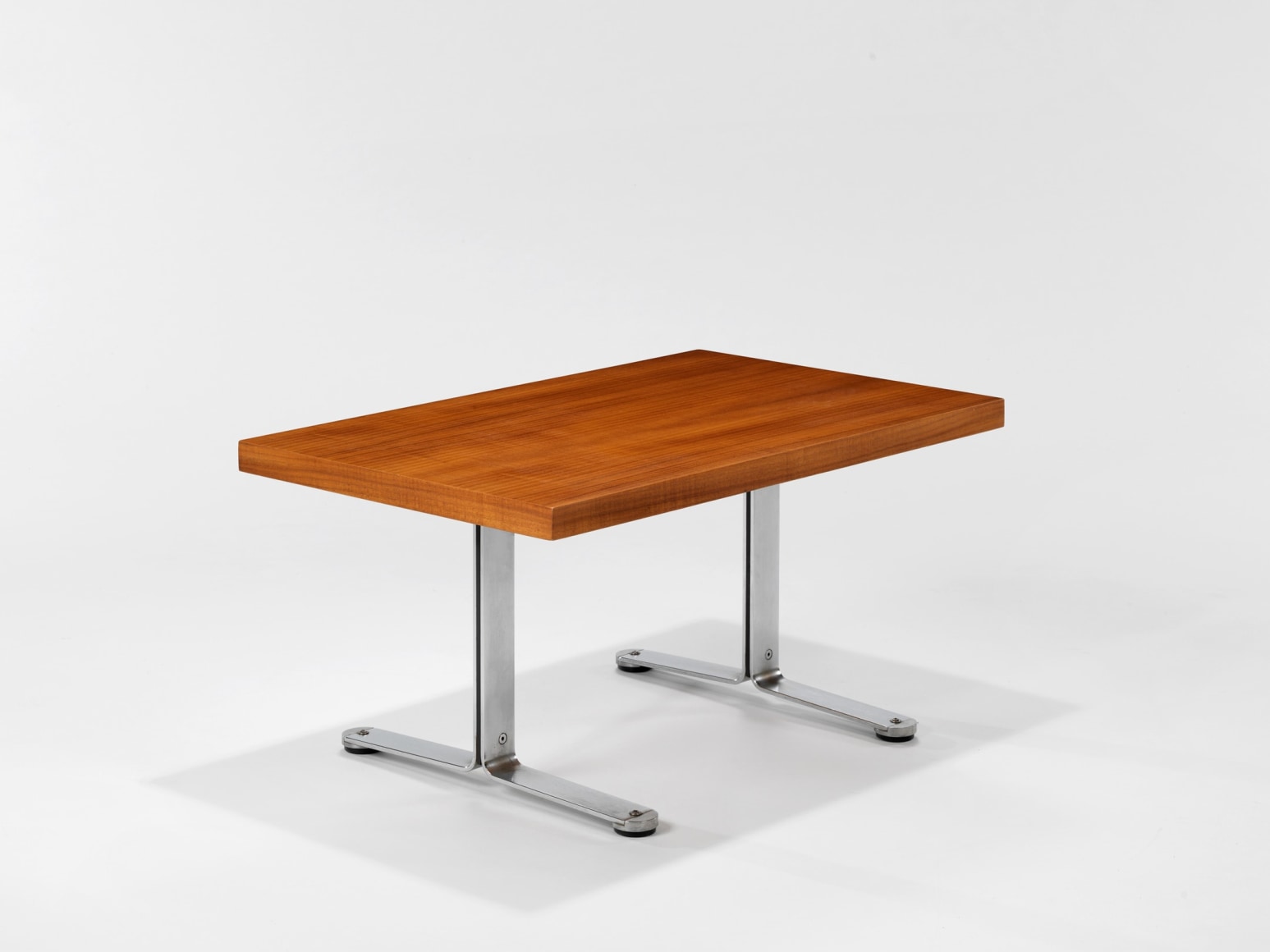 photograph in blank room with table by Tallon made with teak wood top and steel and metal legs
