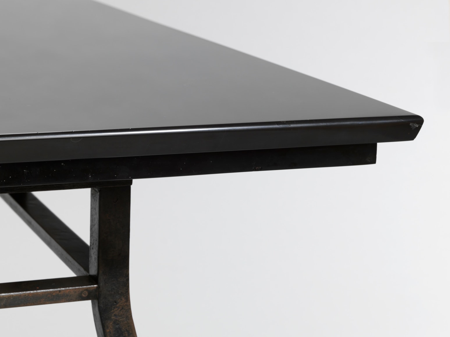 photograph of a black table in a blank room
