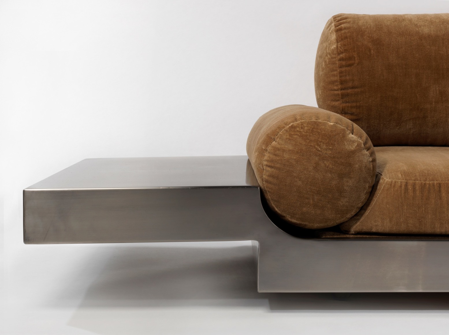 Detail close up of Maria pergay daybed with brown upholstery and steel frame.