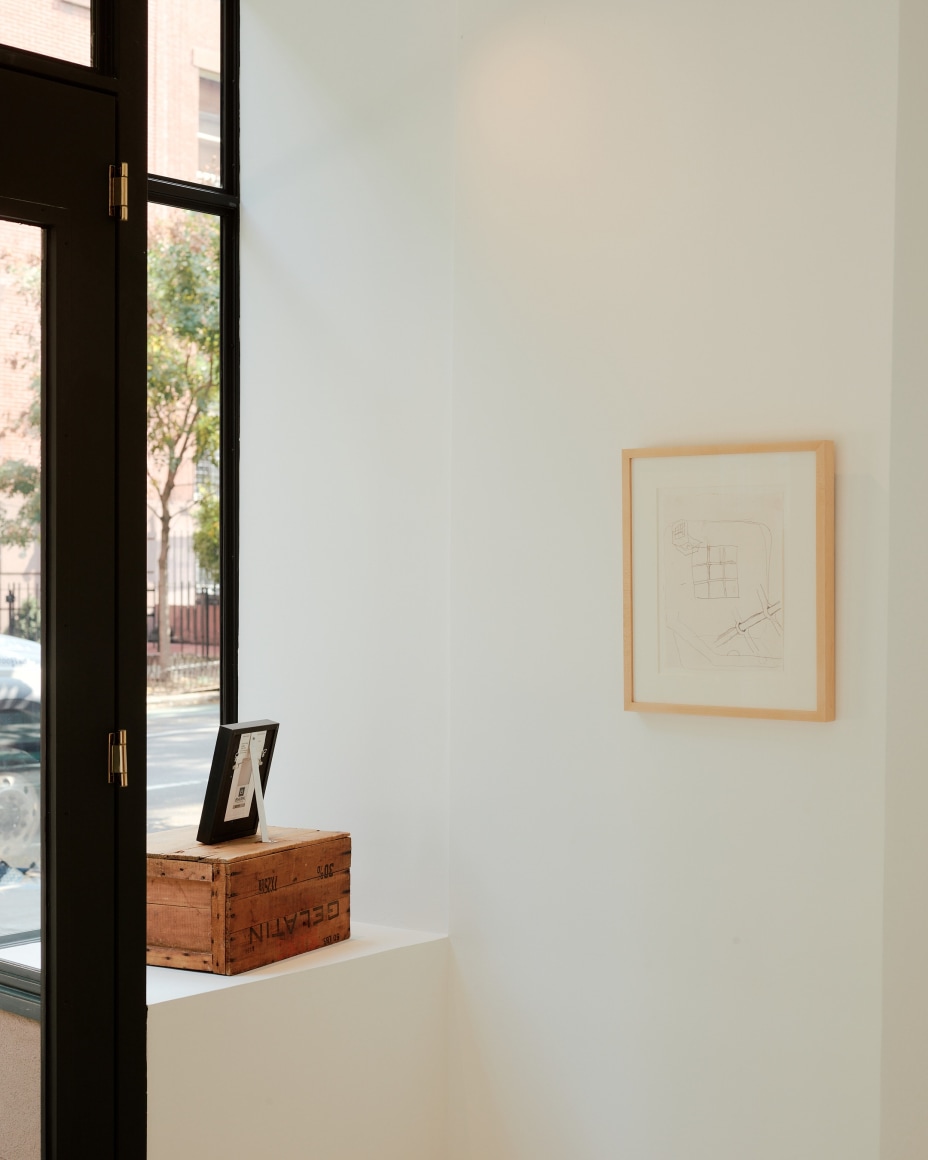 drawing of a drain hangs on a wall in a gallery