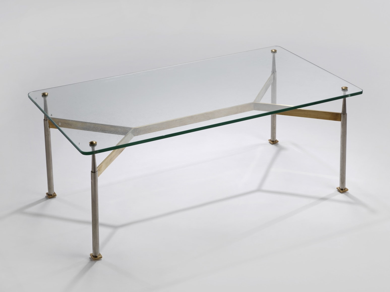 Glass top coffee table with a brass base
