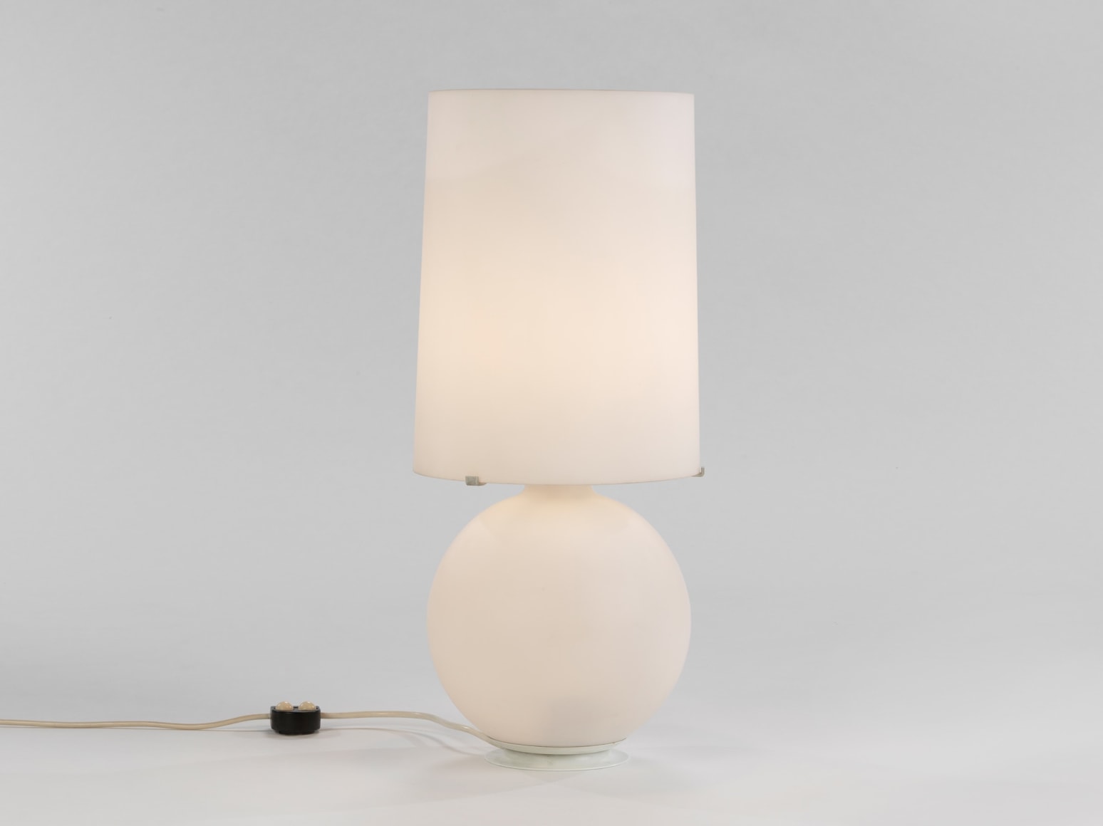 Verre Lumiere Studio lamp made of opaline glass turned on.