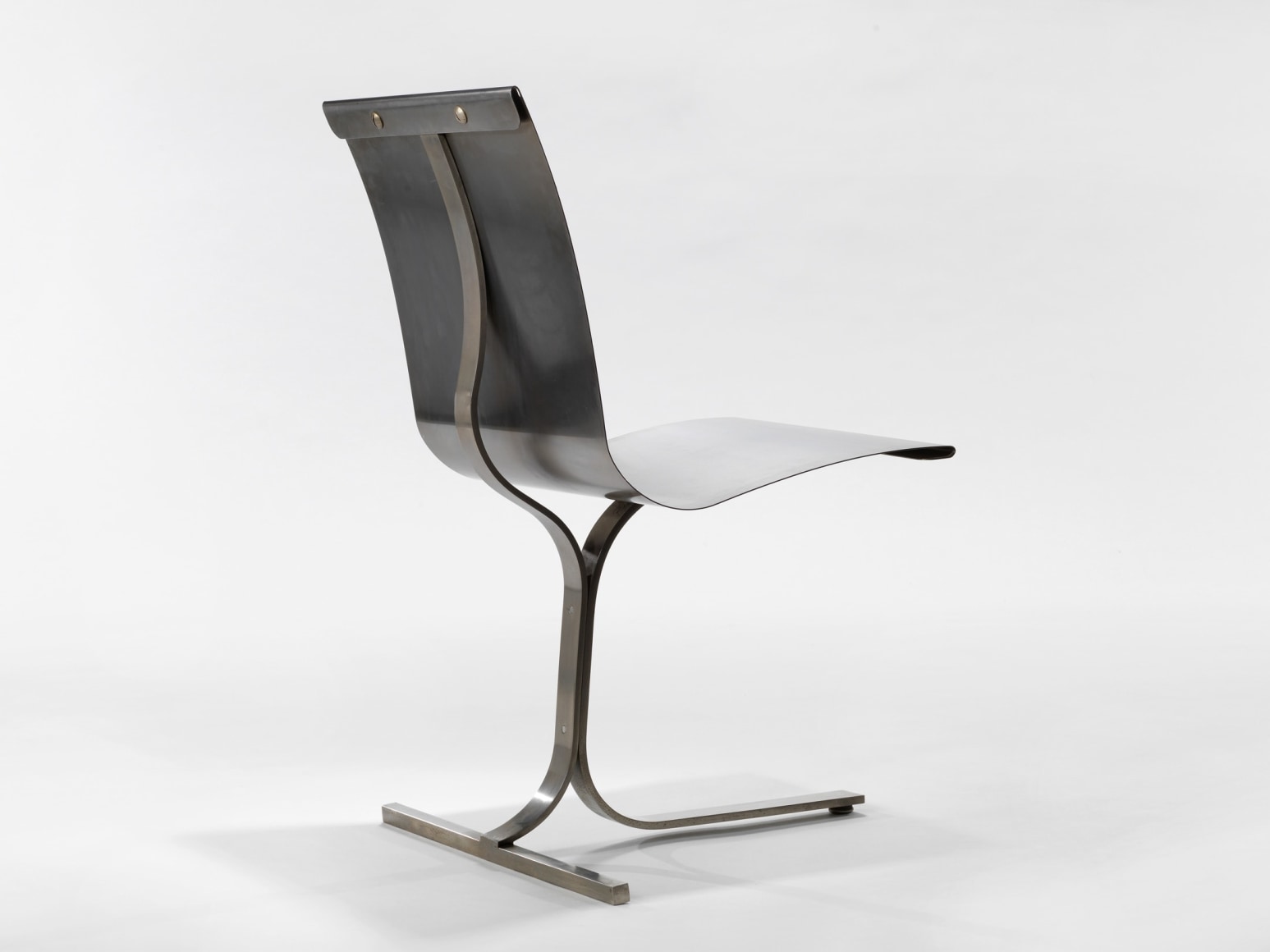 photograph of a blank room with a chair by Charpentier, made of steel