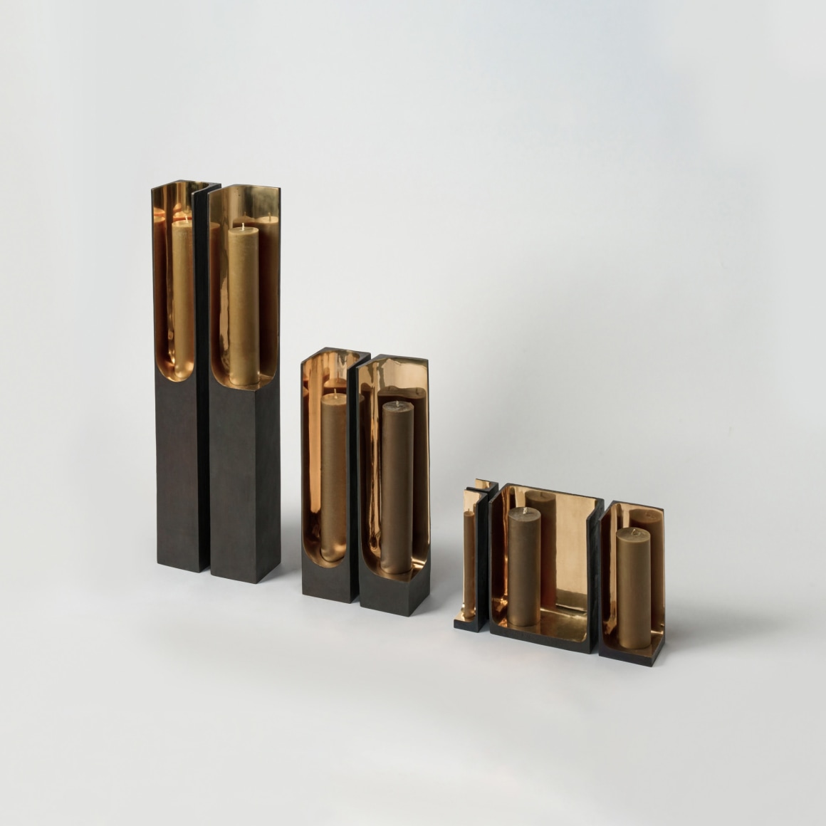 Bronze candlestick with gold detailing and black exterior.