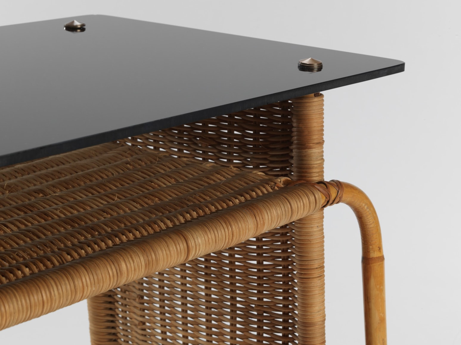 rattan desk in an empty room