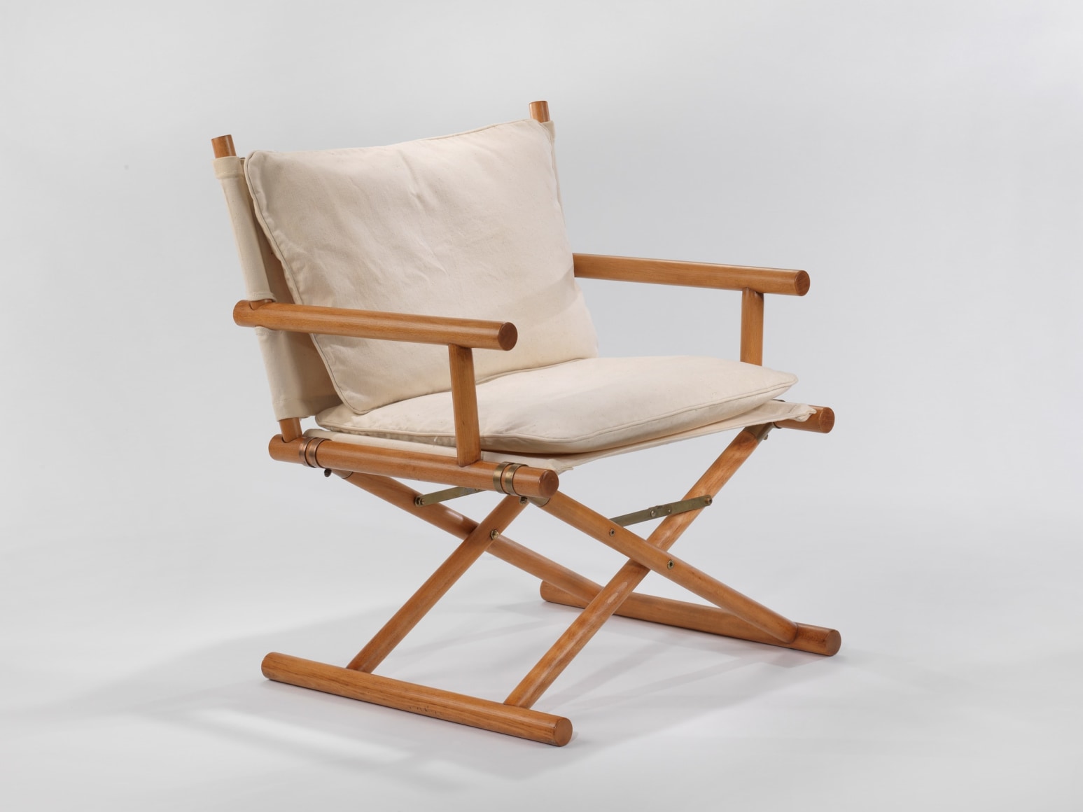 Wooden armchair with cotton upholstery in front of white background