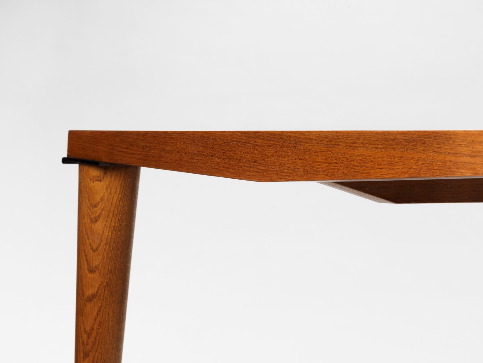 photograph of wood dining table in a blank room