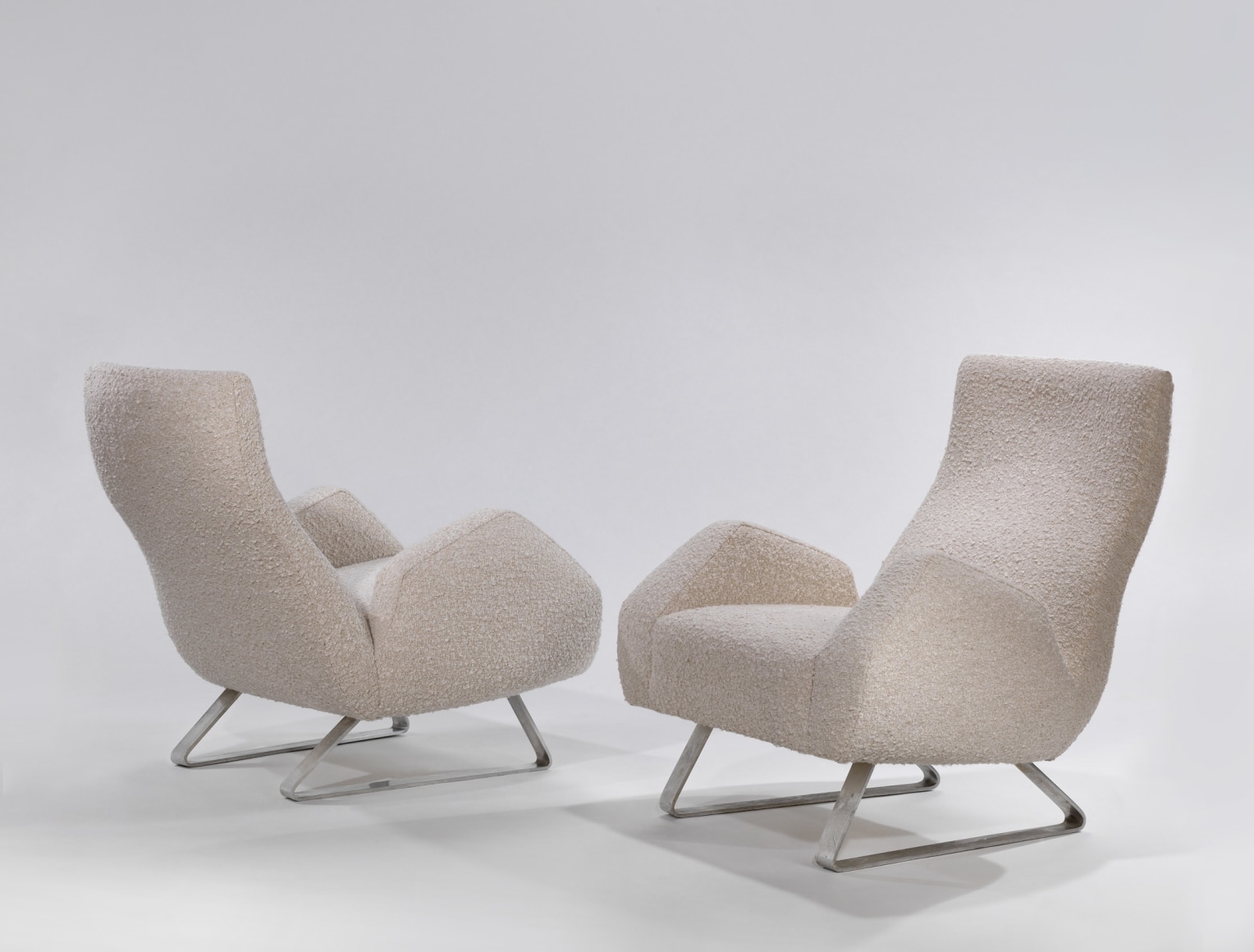 Pair of chairs with white covers made by Jacques Dumond. Metal legs in triangle shape.