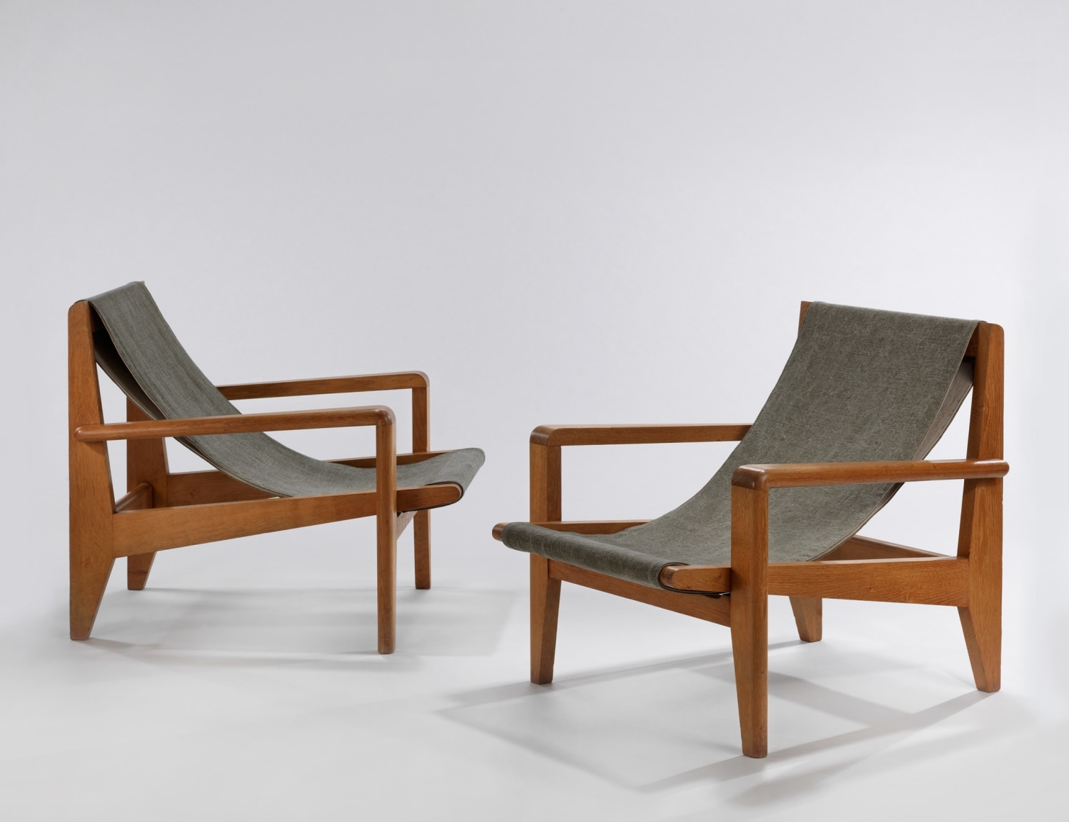 Pair of wood low armchairs with canvas sling seat