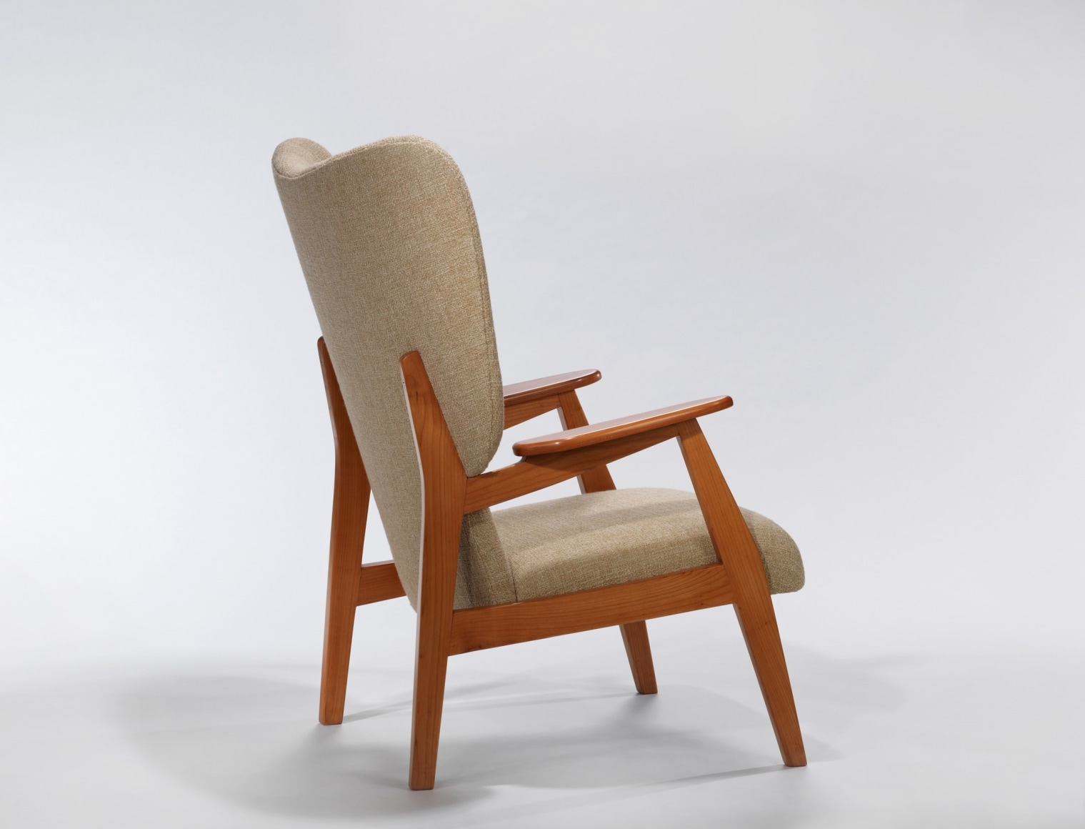Back of cream upholstered chair with wood arms by Ren&eacute;-Jean Caillette