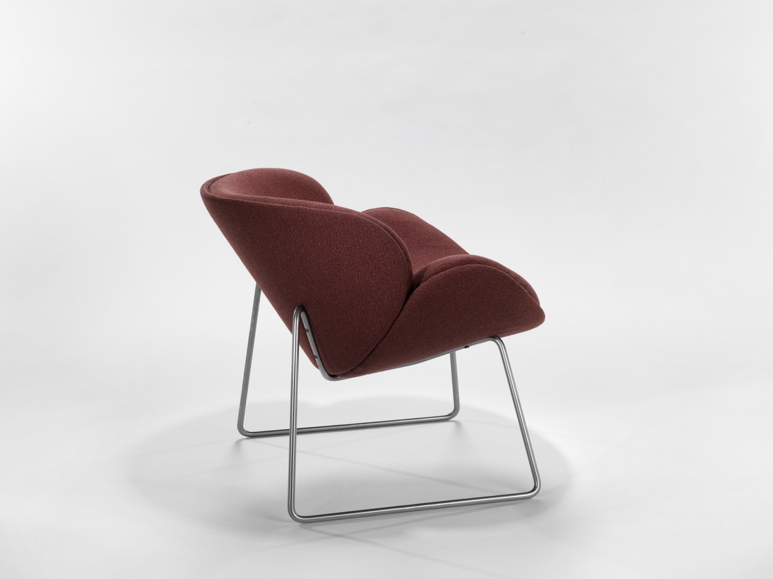 photograph of a chair with metal legs in a blank room