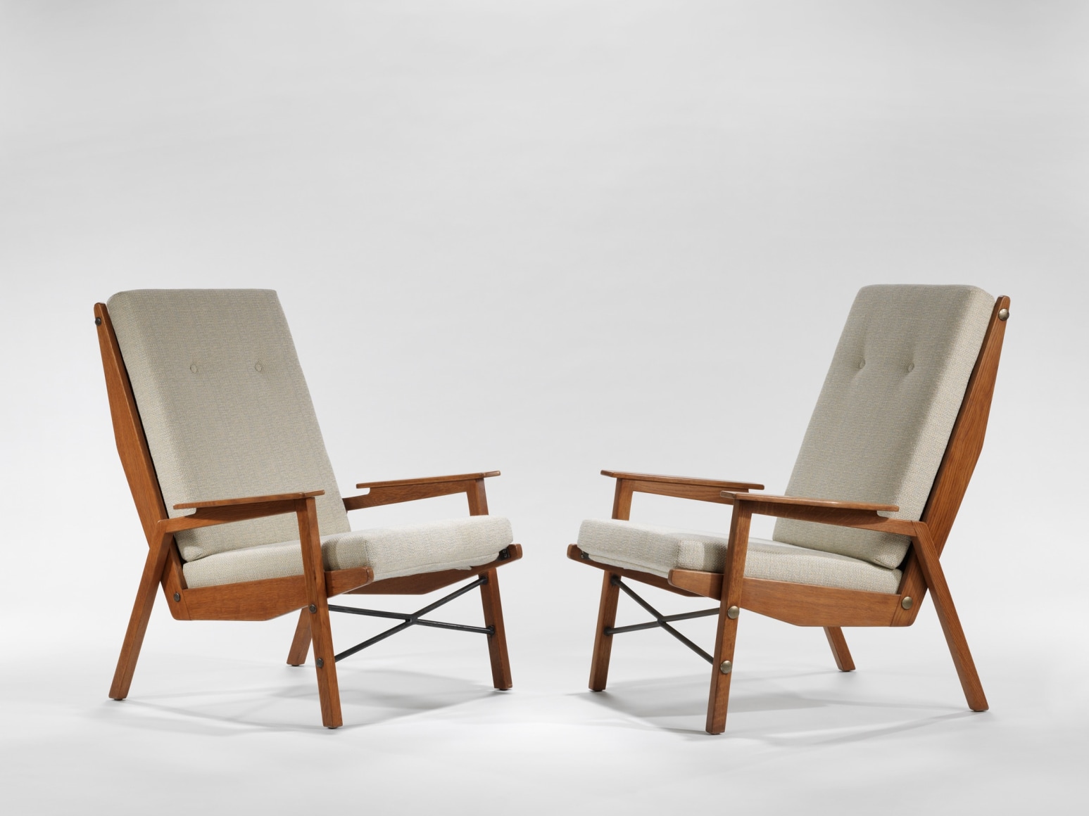 chair with wood legs and arms in a blank room