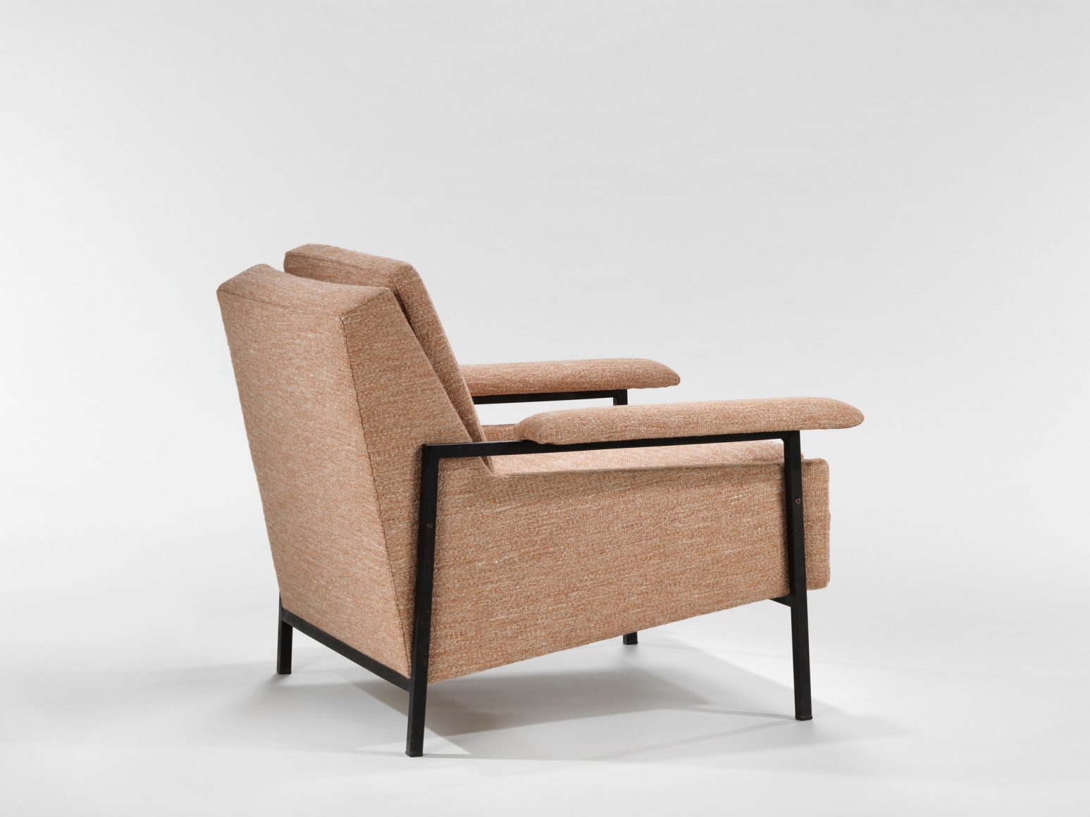 two pink armchairs in an empty room