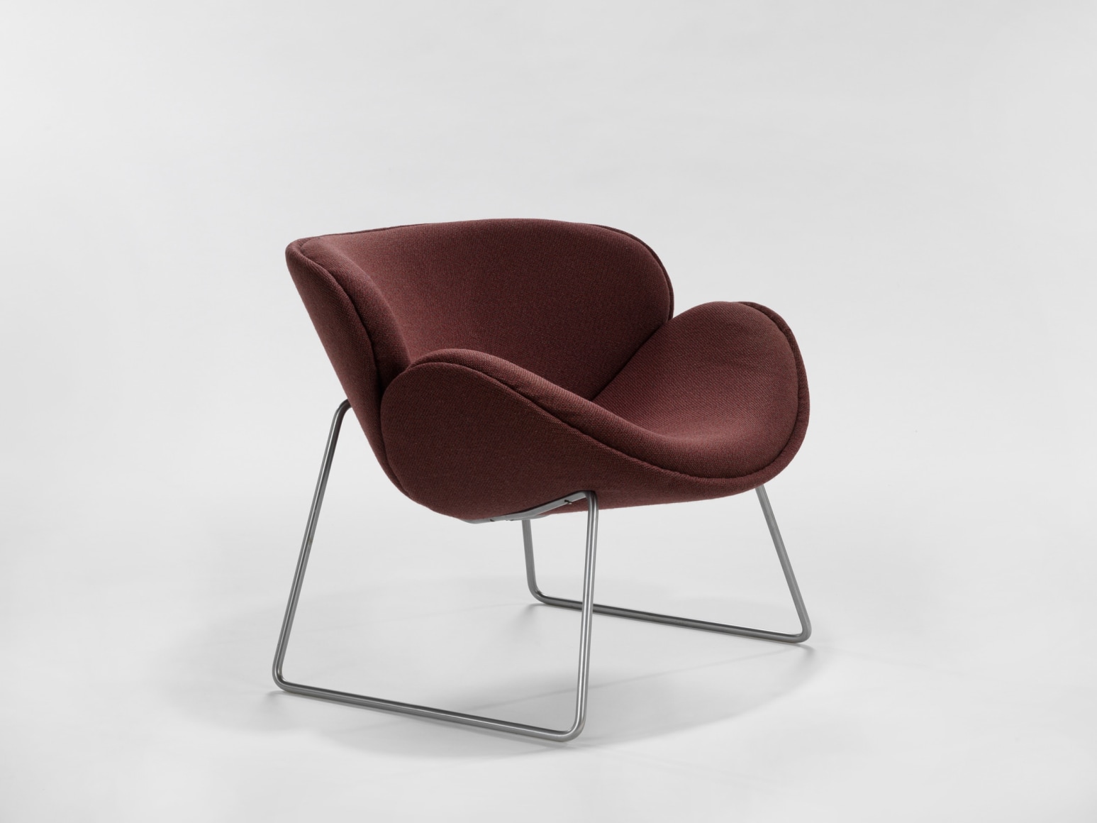 photograph of a chair with metal legs in a blank room