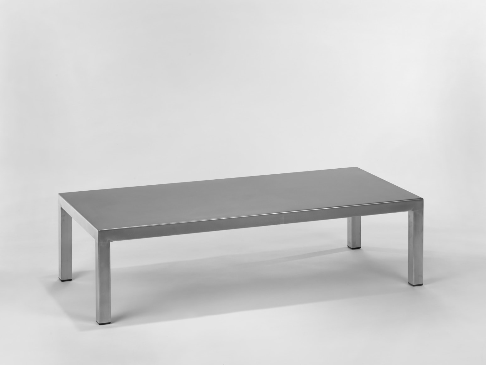 Stainless steel low table in front of white background