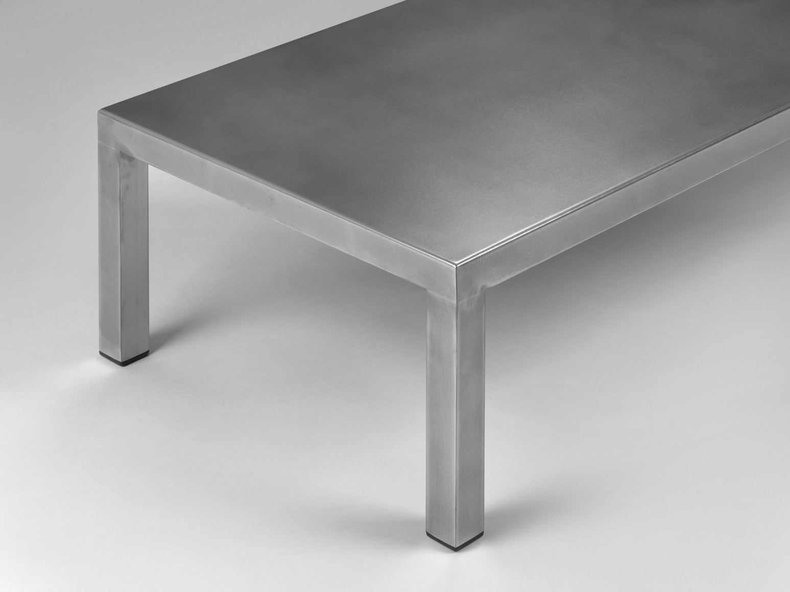 Stainless steel low table in front of white background