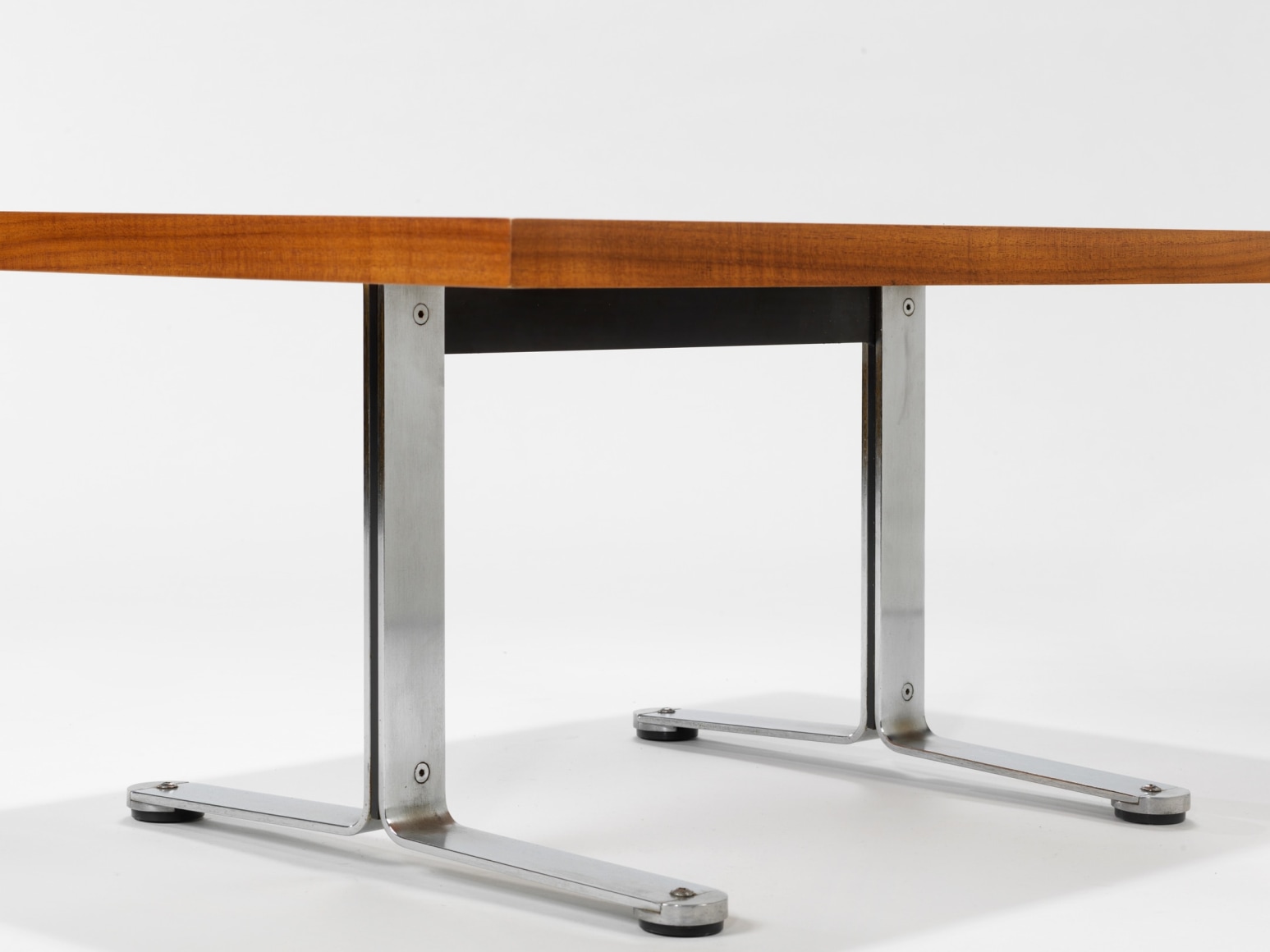 photograph in blank room with table by Tallon made with teak wood top and steel and metal legs
