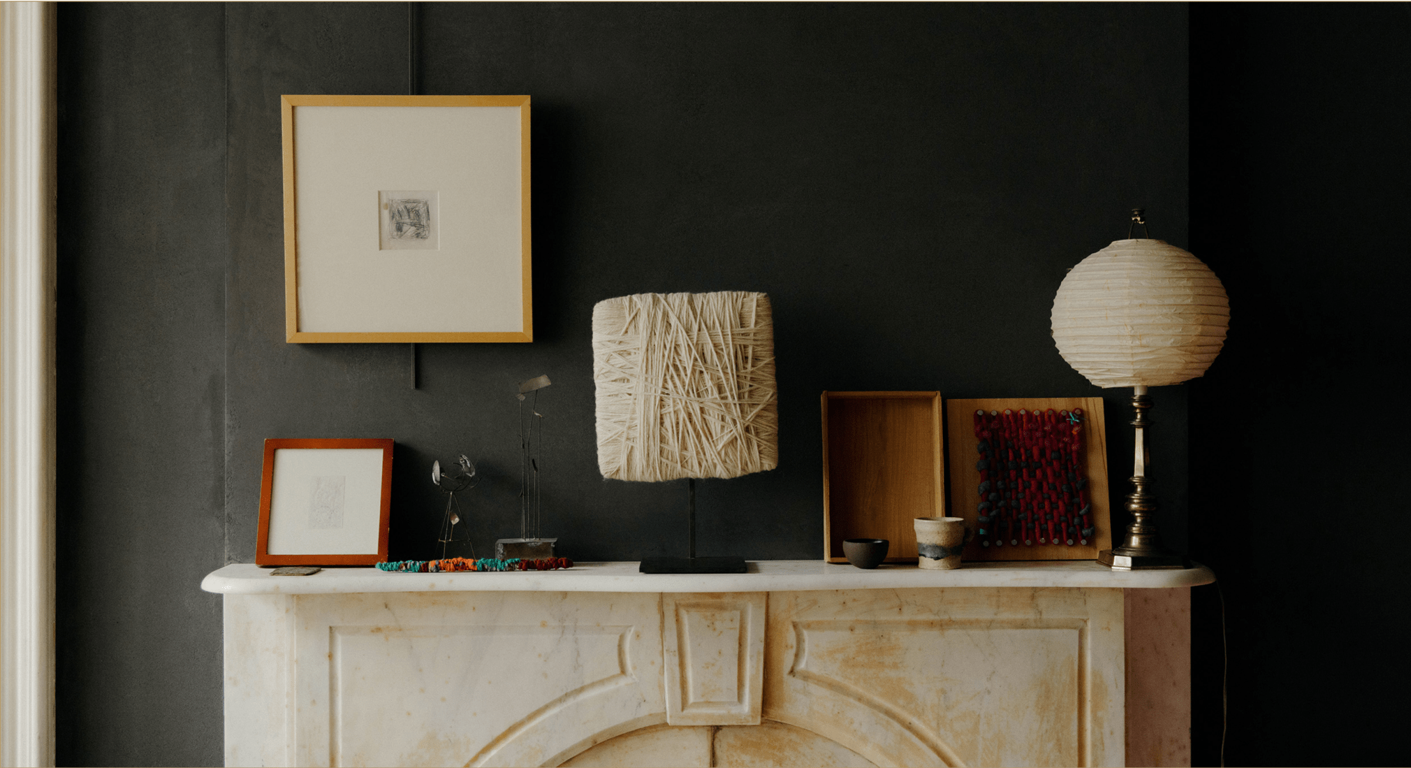 Various objects are displayed on the living room mantel, including works by Joan Mitchell, Sheila Hicks, Joseph Beuys, and Japanese ceramics. (Photo: William Jess Laird)