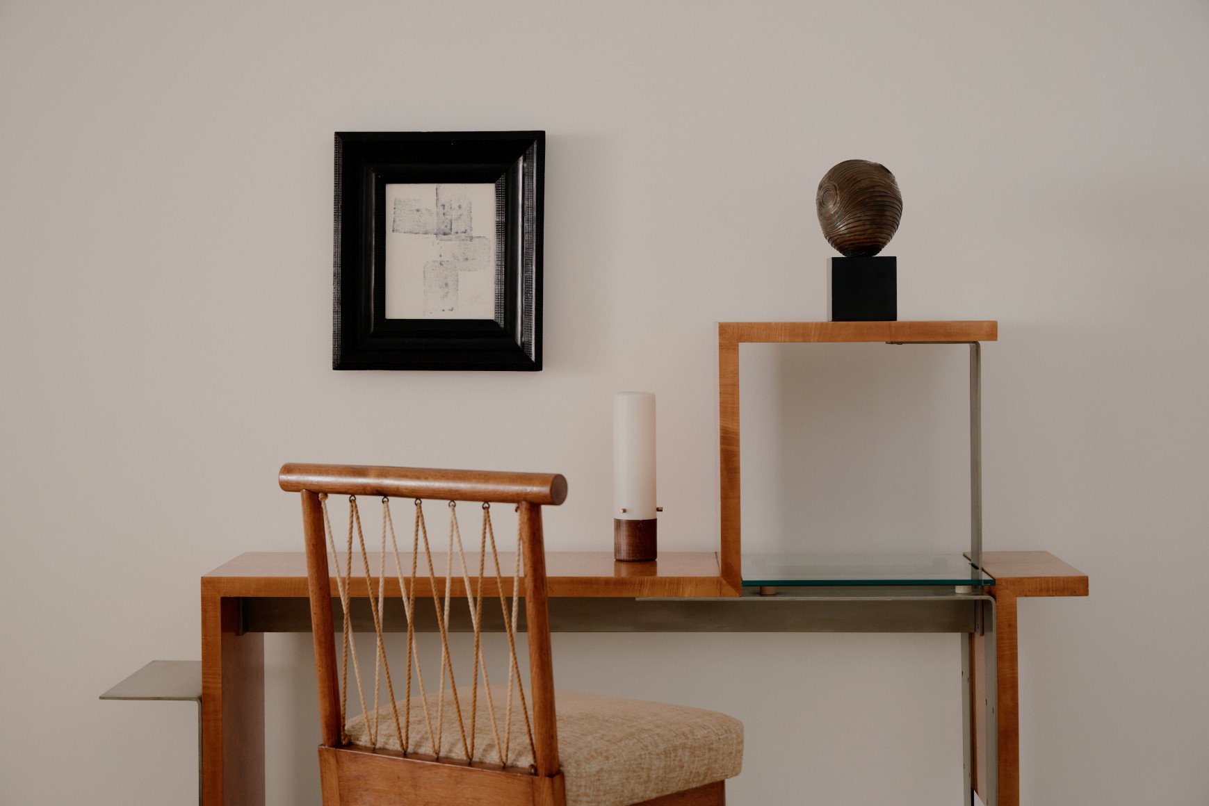Francis Jourdain's wooden asymmetric and Stepped Modernist Console with an upholstered wood and rope chair by Colette Gueden, desk light, pencil and ink wall art, and bronze statue by Vassilakis Takisatop