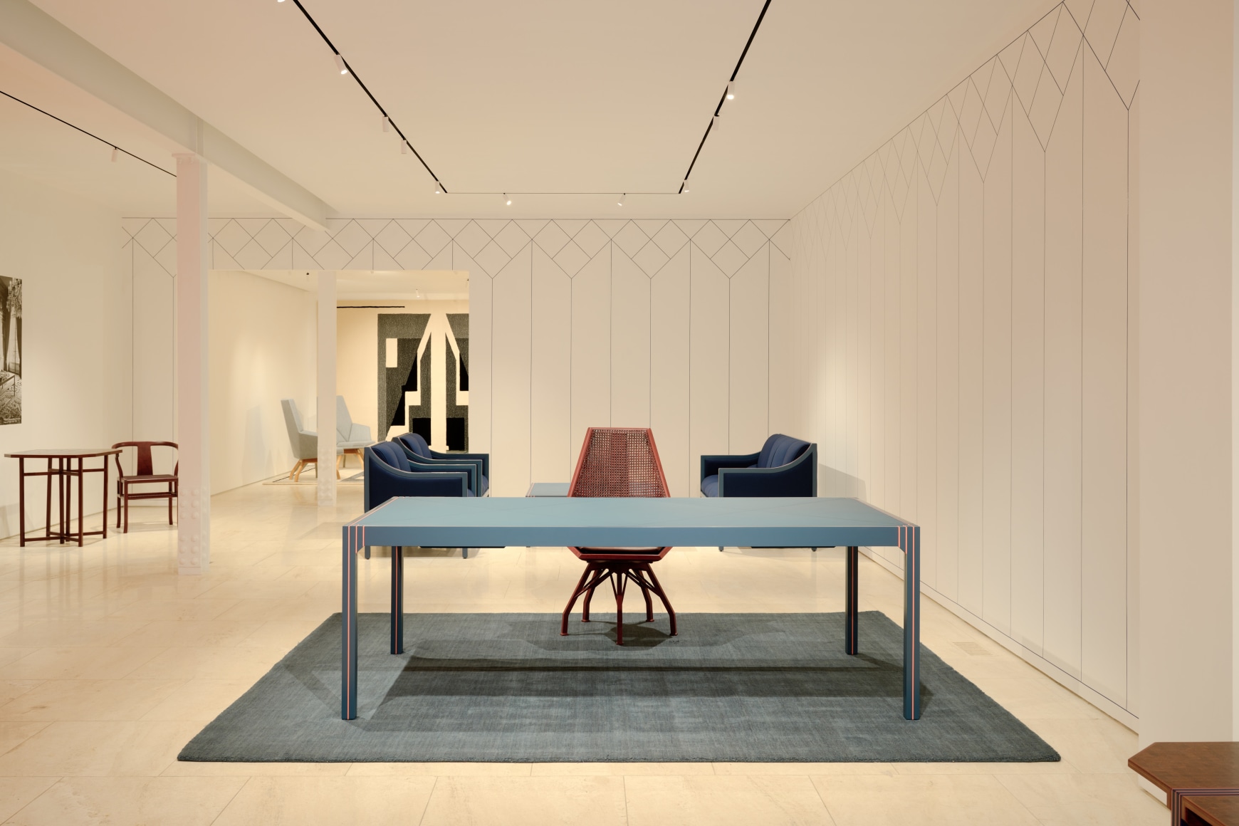 Installation view inside the gallery of works by Pierre Paulin. Multiple in the frame of shot. Many different colors such as blues and reds.