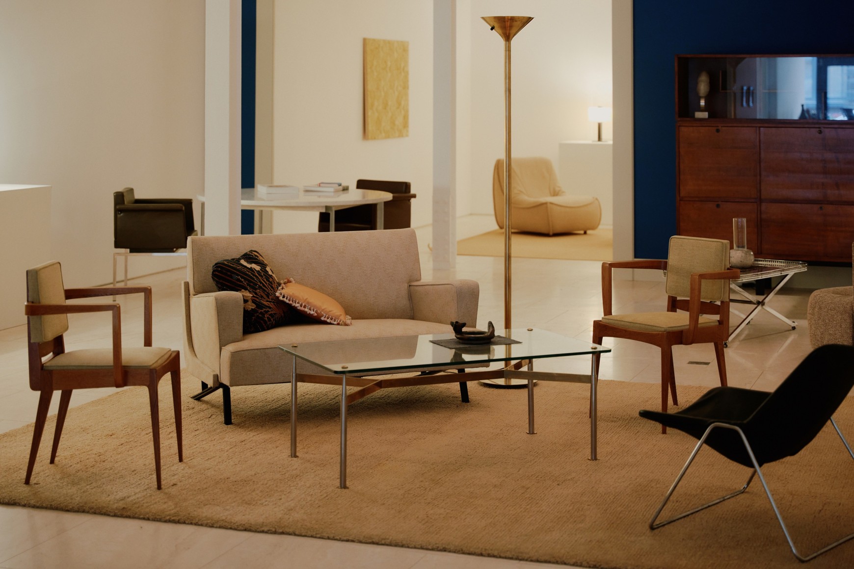 Installation view of works in the gallery, mostly furniture and some rugs and art. Main room view.