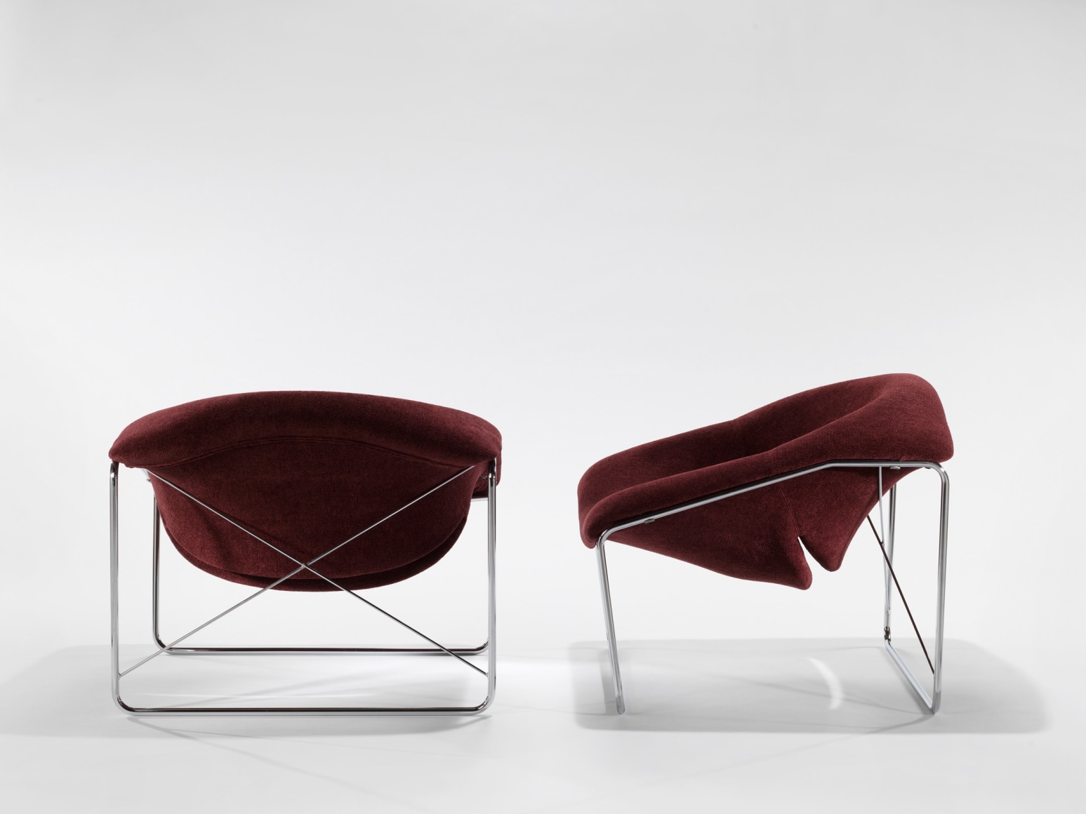 photograph of chair in a blank room with metal legs