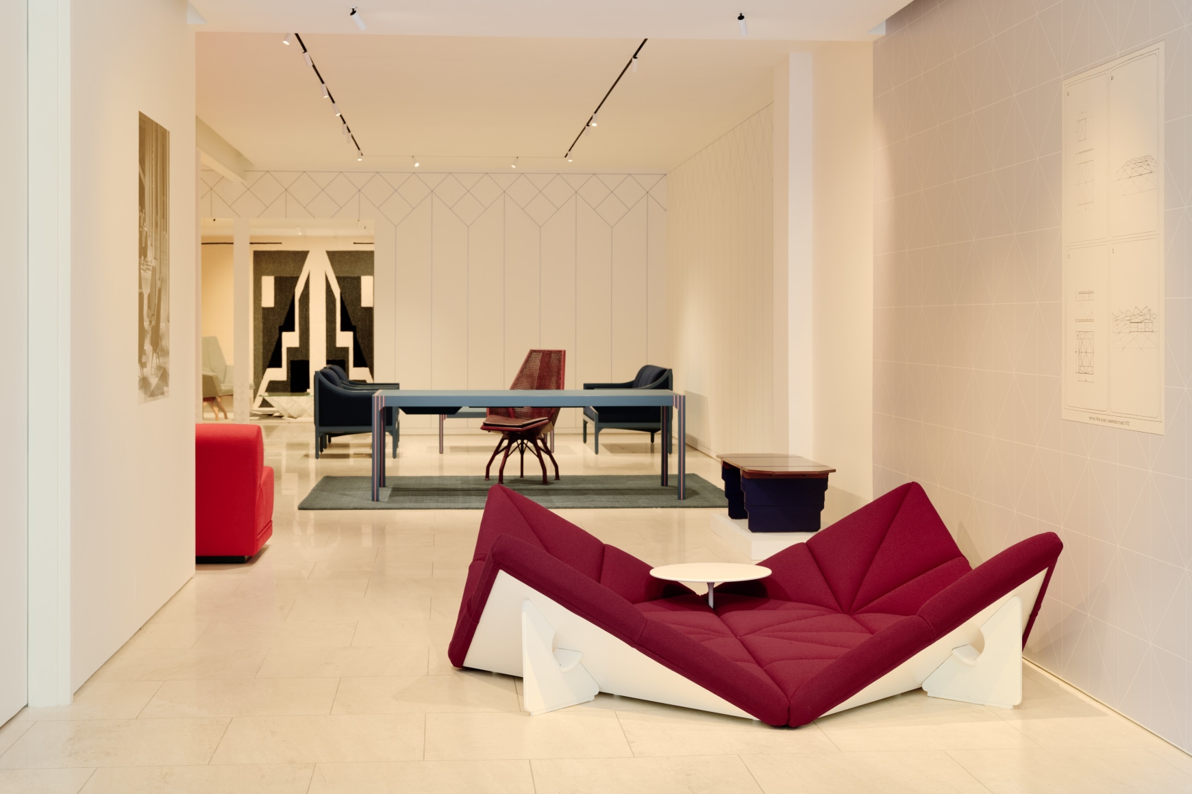 Installation view inside the gallery of works by Pierre Paulin. Multiple in the frame of shot. Many different colors such as blues and reds.