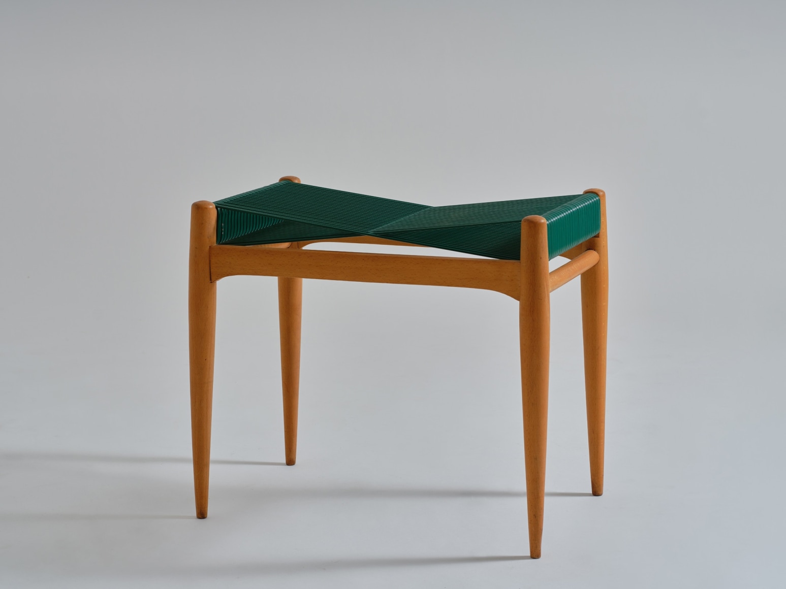 mcm stool in an empty room