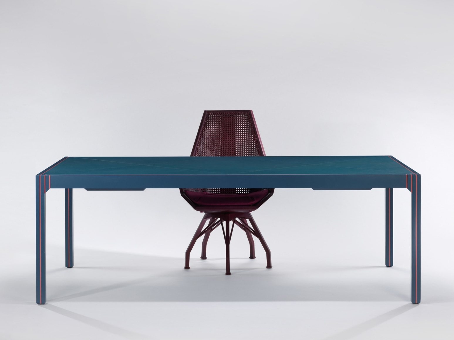 Blue lacquered desk with orange detailing with President Desk Chair by Pierre Paulin
