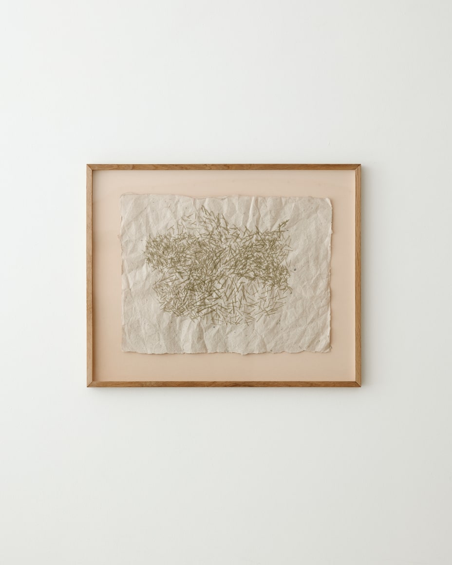 a work of art hangs on a white wall