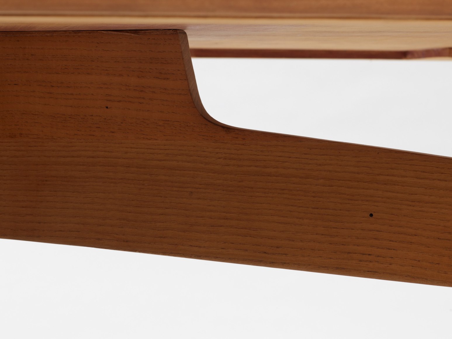 photograph of a wood desk in a blank room
