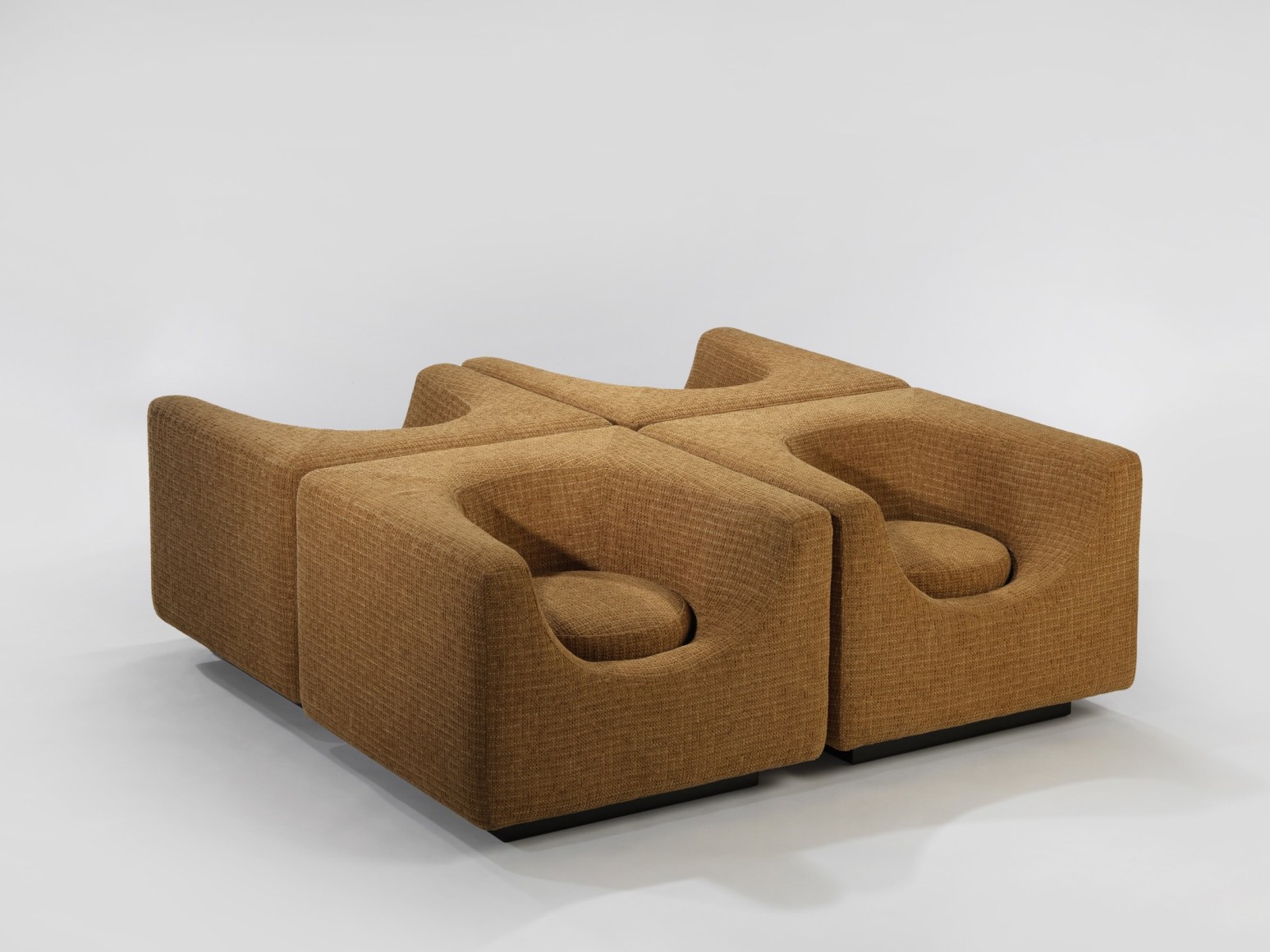 photograph of brown armchairs in a blank room