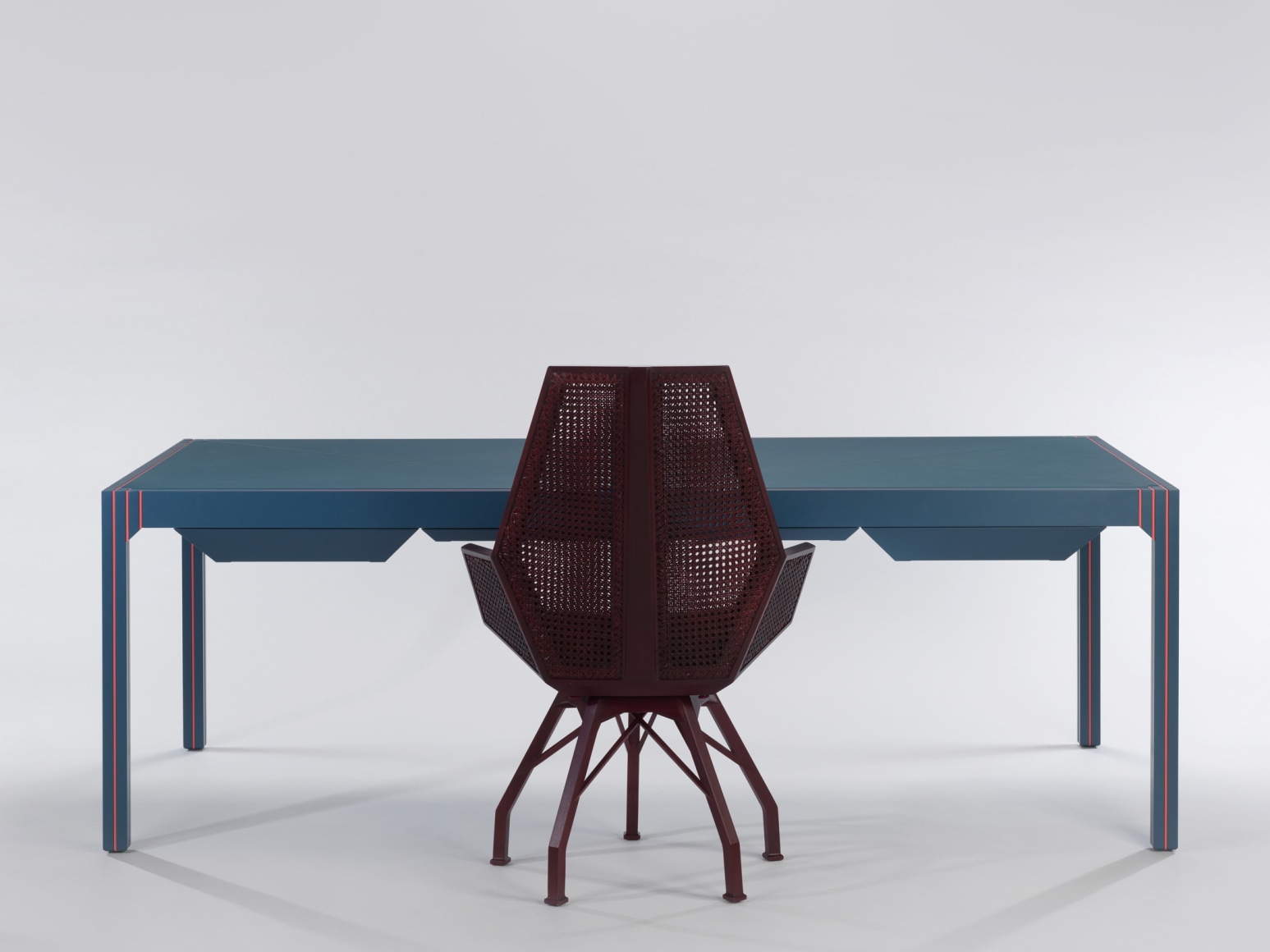 Blue lacquered desk with orange detailing with President Desk Chair by Pierre Paulin