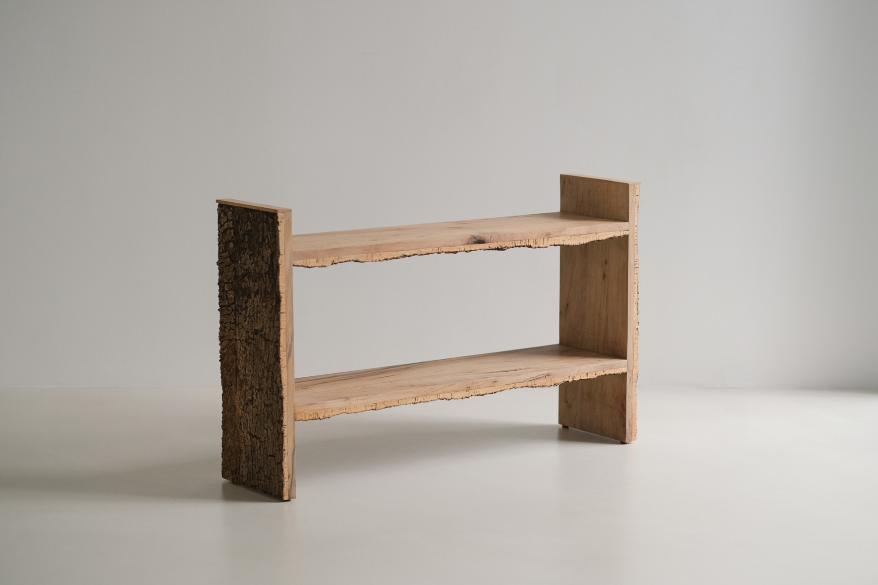 Bookshelf made of oak and cork standing against a grey background.