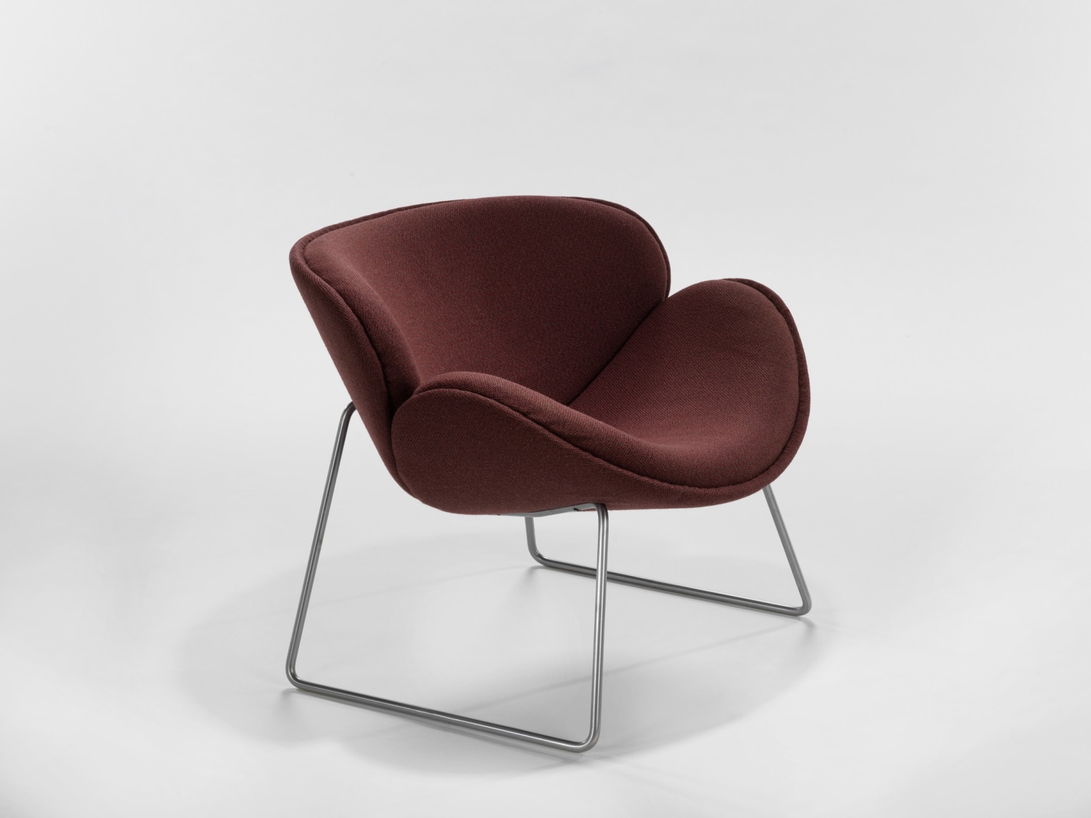 photograph of a chair with metal legs in a blank room