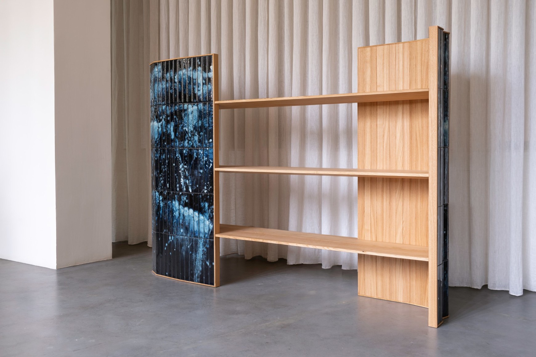 wooden bookshelf with blue panels in a room