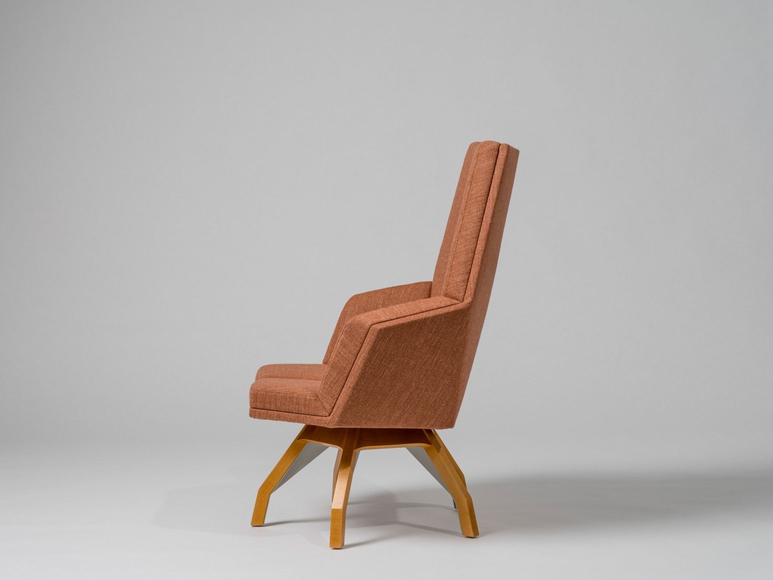 Side view of wood based upholstered lounge chair by Pierre Paulin