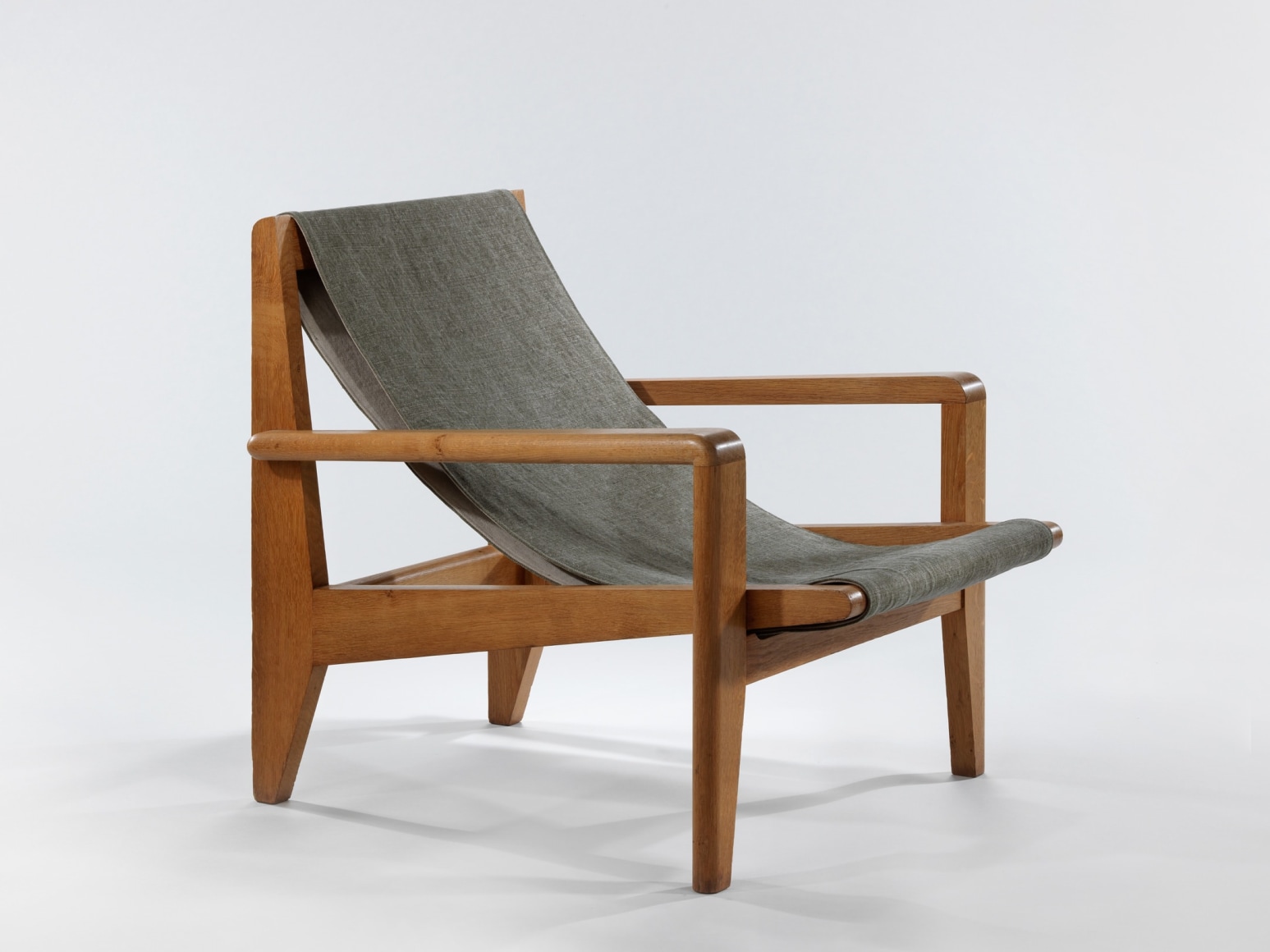 Low wood armchairs with canvas sling seat