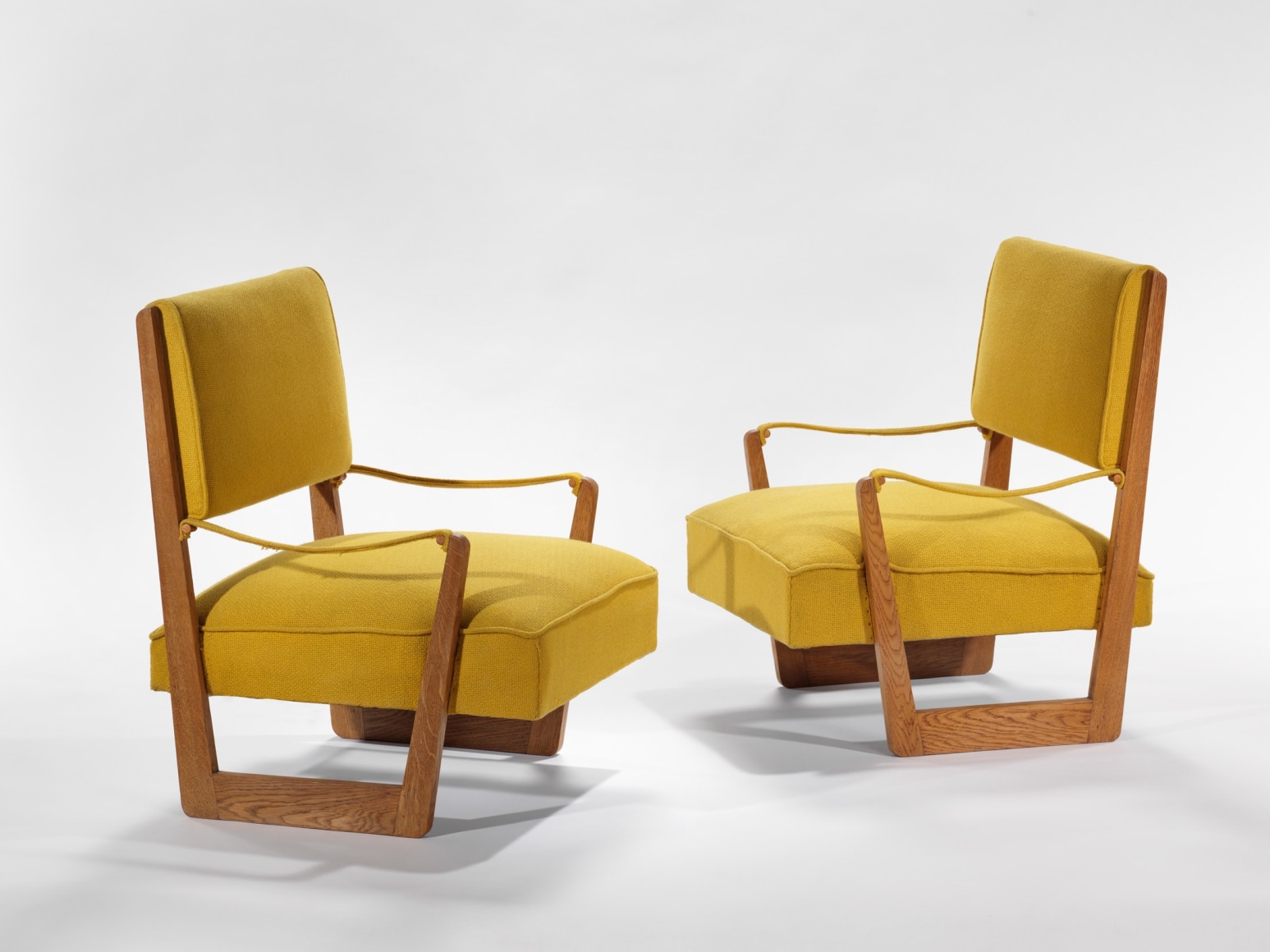 yellow and wood armchairs in an empty room